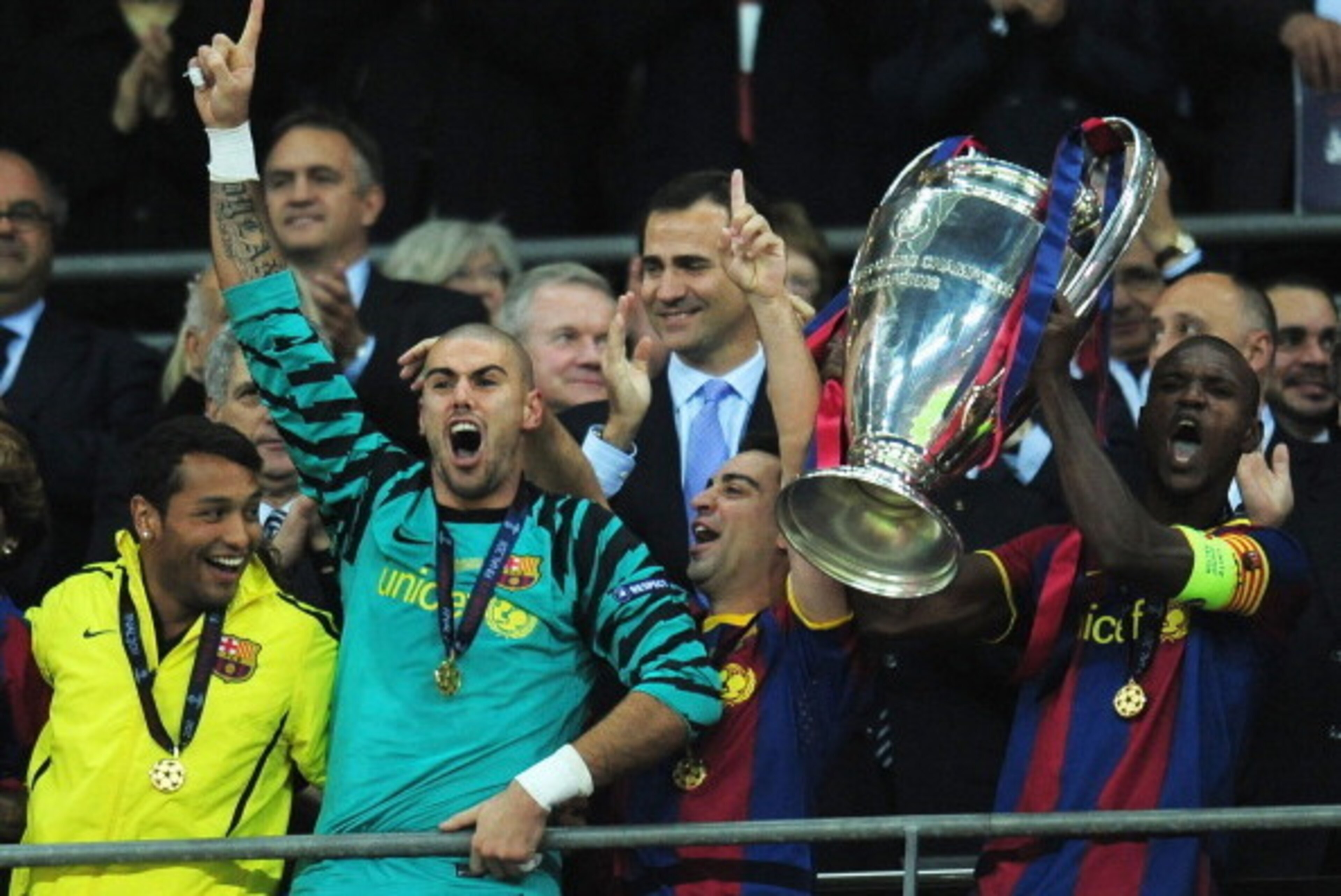 LONDON, ENGLAND - MAY 28:  Prince Felipe Of Spain applauds as Eric Abidal (R) of FC Barcelona lifts the trophy and celebrates with teammates after victory in the UEFA Champions League final between FC Barcelona and Manchester United FC at Wembley Stadium 