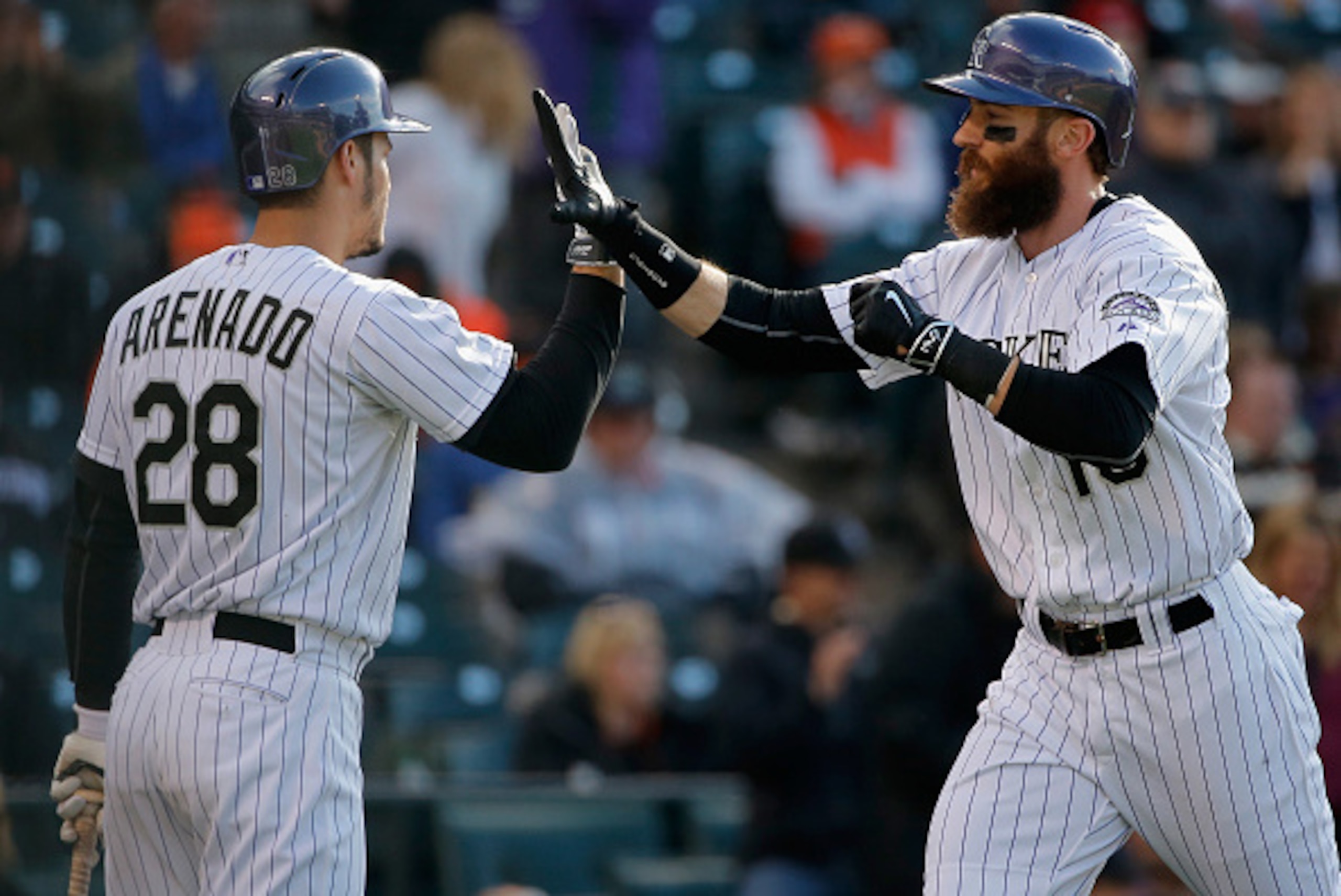 DENVER, CO - MAY 23:  Charlie Blackmon #19 of the Colorado Rockies celebrates his two run home run off of Chris Heston #53 of the San Francisco Giants with Nolan Arenado #28 of the Colorado Rockies as the Giants held a 7-4 lead in the fifth inning during 