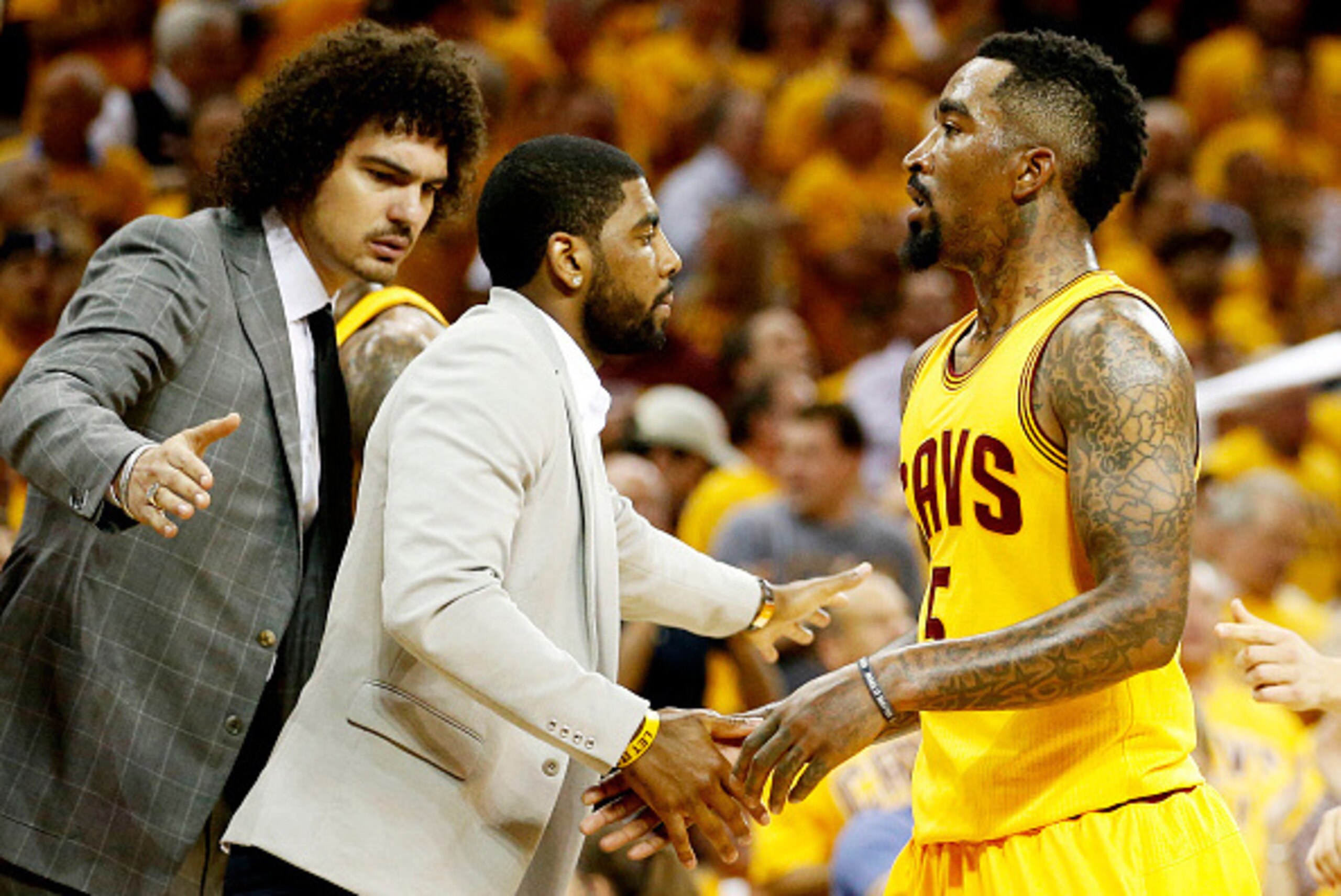 CLEVELAND, OH - MAY 24:  J.R. Smith #5 of the Cleveland Cavaliers is greeted by Anderson Varejao #17 and Kyrie Irving #2 in the second quarter against the Atlanta Hawks during Game Three of the Eastern Conference Finals of the 2015 NBA Playoffs at Quicken