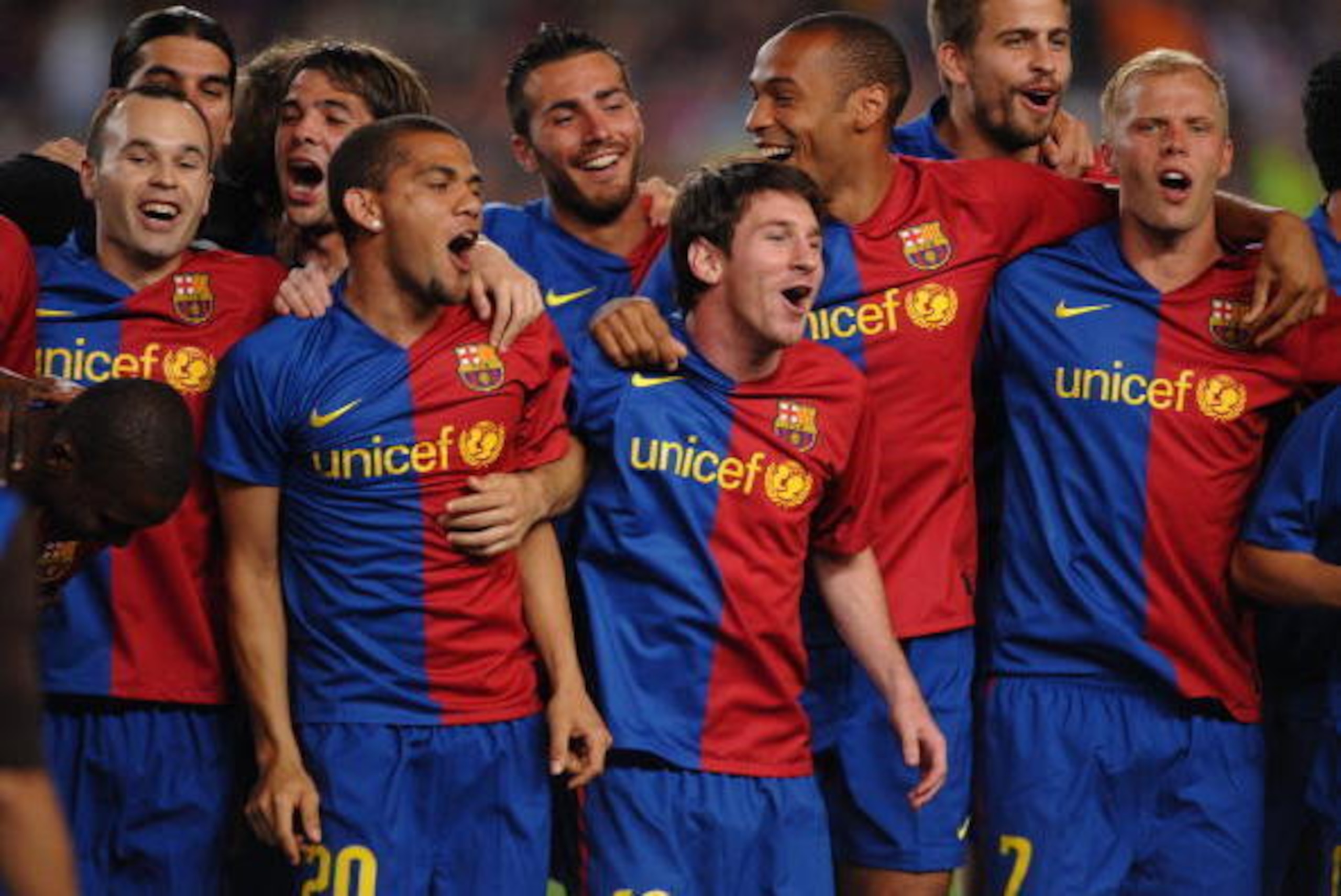 BARCELONA, SPAIN - MAY 23: Andres Iniesta (L) Dani Alves (2.L) Leo Messi (C) and  Eidur Gudjohnsen celebrate with the La Liga trophy after the La Liga match between Barcelona and Osasuna at the Nou Camp stadium on May 23, 2009 in Barcelona, Spain.  (Photo