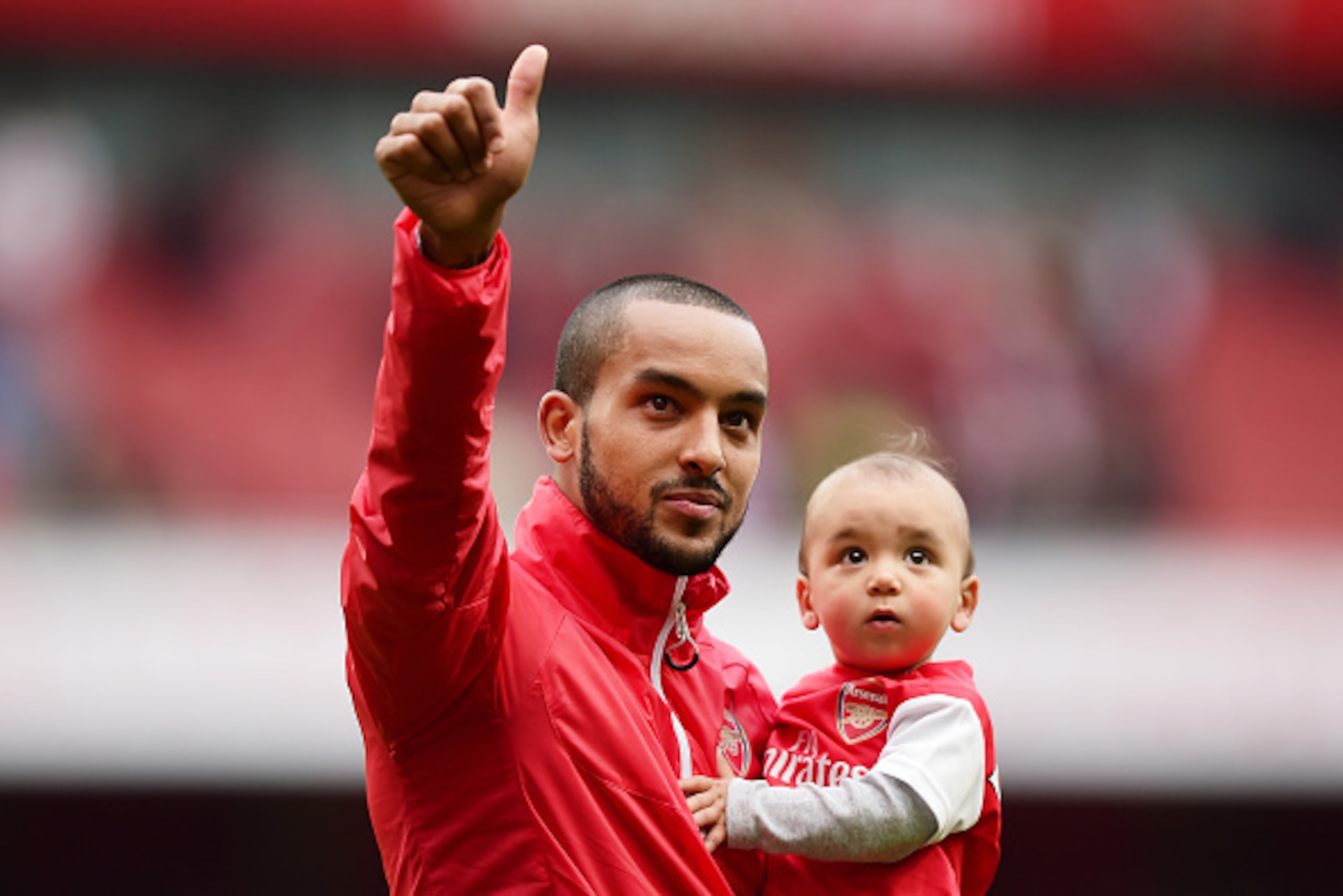 LONDON, ENGLAND - MAY 24:  Theo Walcott of Arsenal holding his children waves to supporters after the Barclays Premier League match between Arsenal and West Bromwich Albion at Emirates Stadium on May 24, 2015 in London, England.  (Photo by Jamie McDonald/
