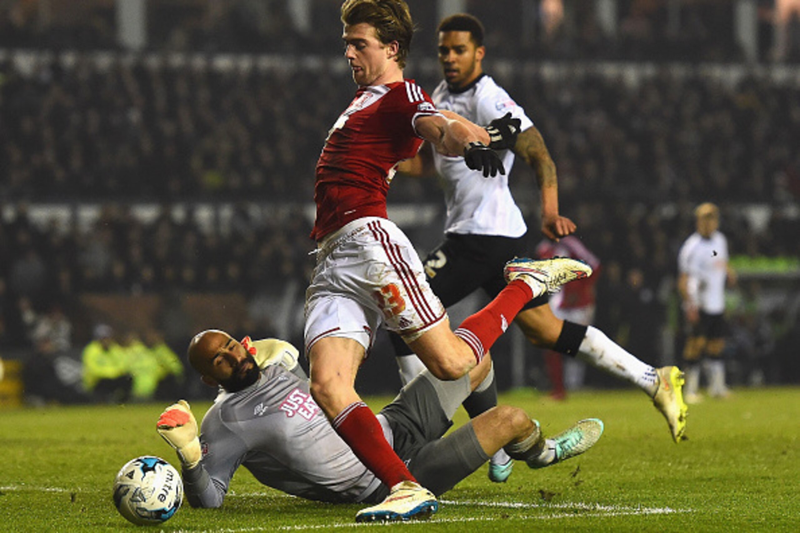 DERBY, ENGLAND - MARCH 17:  Patrick Bamford of Middlesbrough rounds goalkeeper Lee Grant of Derby to score opening goal during the Sky Bet Championship match between Derby County and Middlesbrough at iPro Stadium on March 17, 2015 in Derby, England.  (Pho