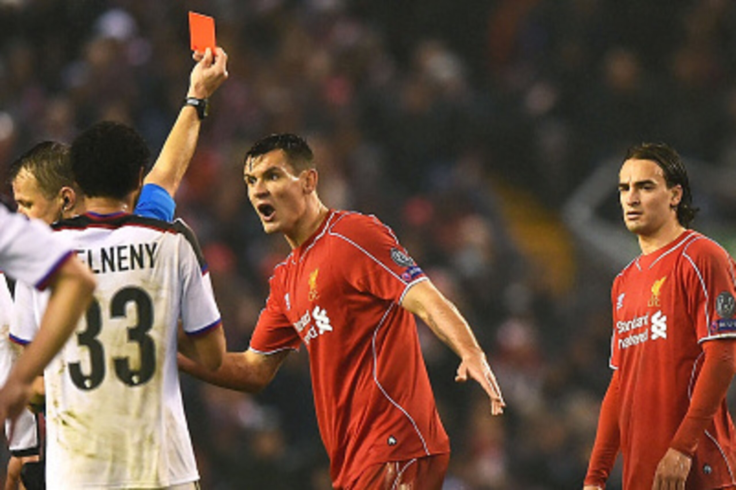 LIVERPOOL, ENGLAND - DECEMBER 09:  Dejan Lovren #6 of Liverpool reacts as teammate Lazar Markovic #50 of Liverpool is shown the red card card during the UEFA Champions League group B match between Liverpool and FC Basel 1893 at Anfield on December 9, 2014