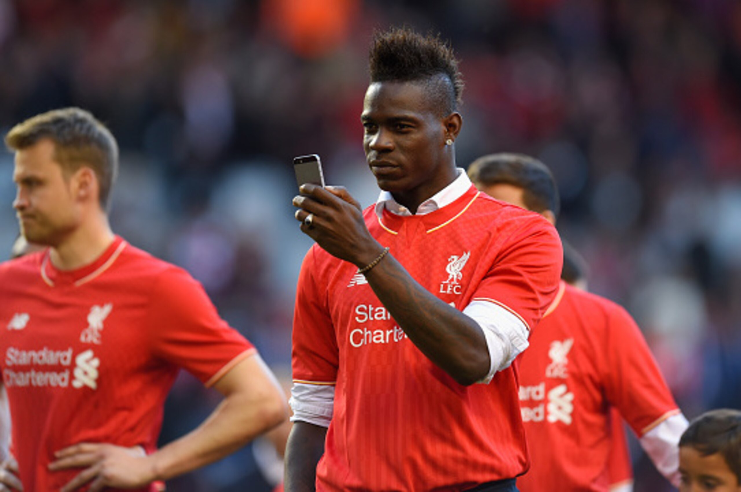 LIVERPOOL, ENGLAND - MAY 16:  Mario Balotelli of Liverpool takes pictures of the fans on his phone after the Barclays Premier League match betrween Liverpool and Crystal Palace at Anfield on May 16, 2015 in Liverpool, England.  (Photo by Stu Forster/Getty