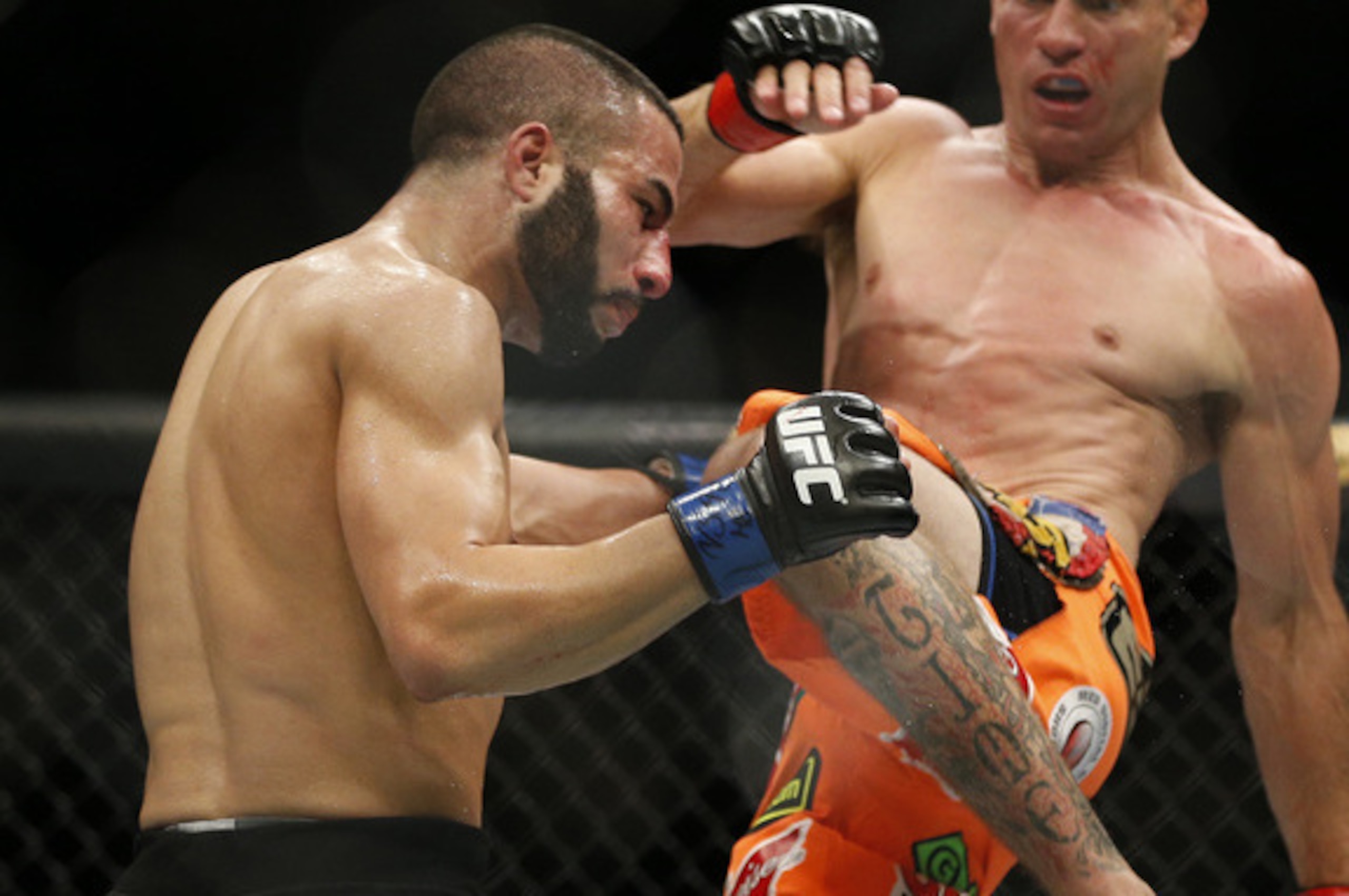 Makdessi (left) absorbs a blow from Donald Cerrone at UFC 187.
