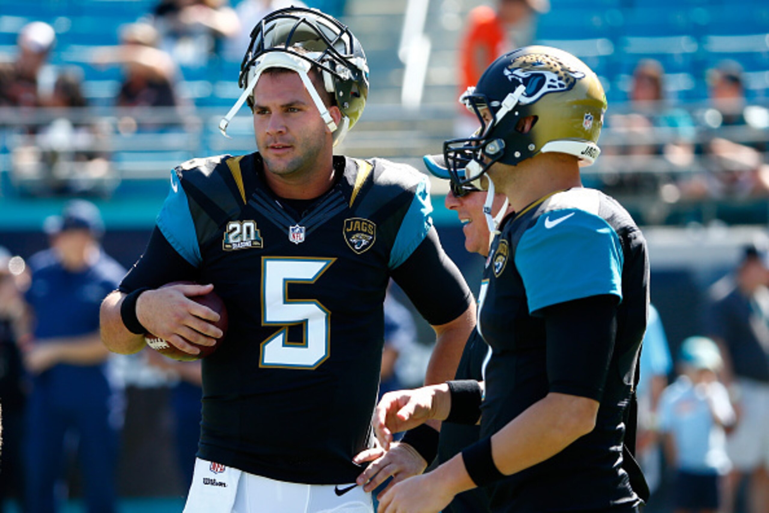 JACKSONVILLE, FL - OCTOBER 19:   Blake Bortles #5 of the Jacksonville Jaguars speaks with  Chad Henne #7 before the game against the Cleveland Browns at EverBank Field on October 19, 2014 in Jacksonville, Florida.  (Photo by Sam Greenwood/Getty Images)