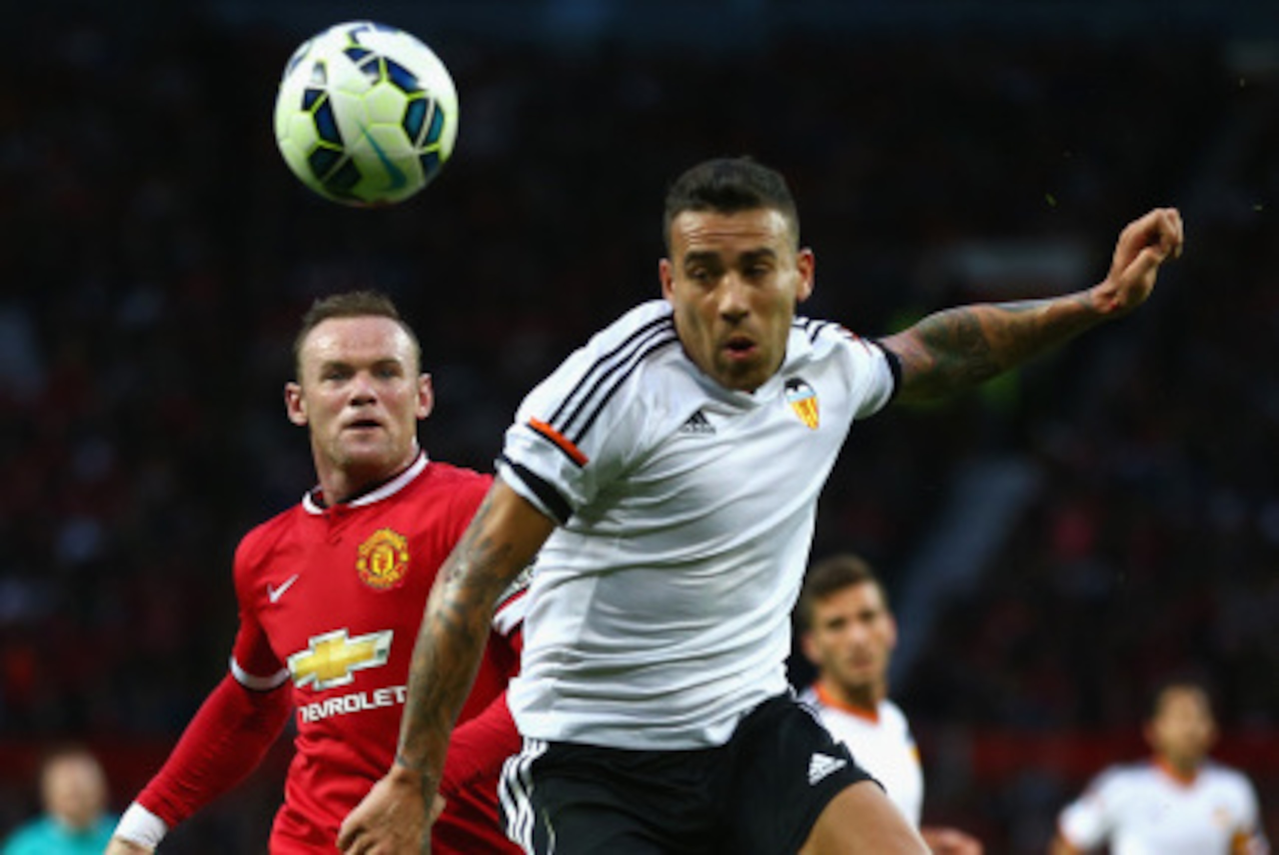 MANCHESTER, ENGLAND - AUGUST 12: Wayne Rooney of Manchester United in action with  Nicolas Otamendi of Valencia during the Pre Season Friendly match between Manchester United and Valencia at Old Trafford on August 12, 2014 in Manchester, England.  (Photo 