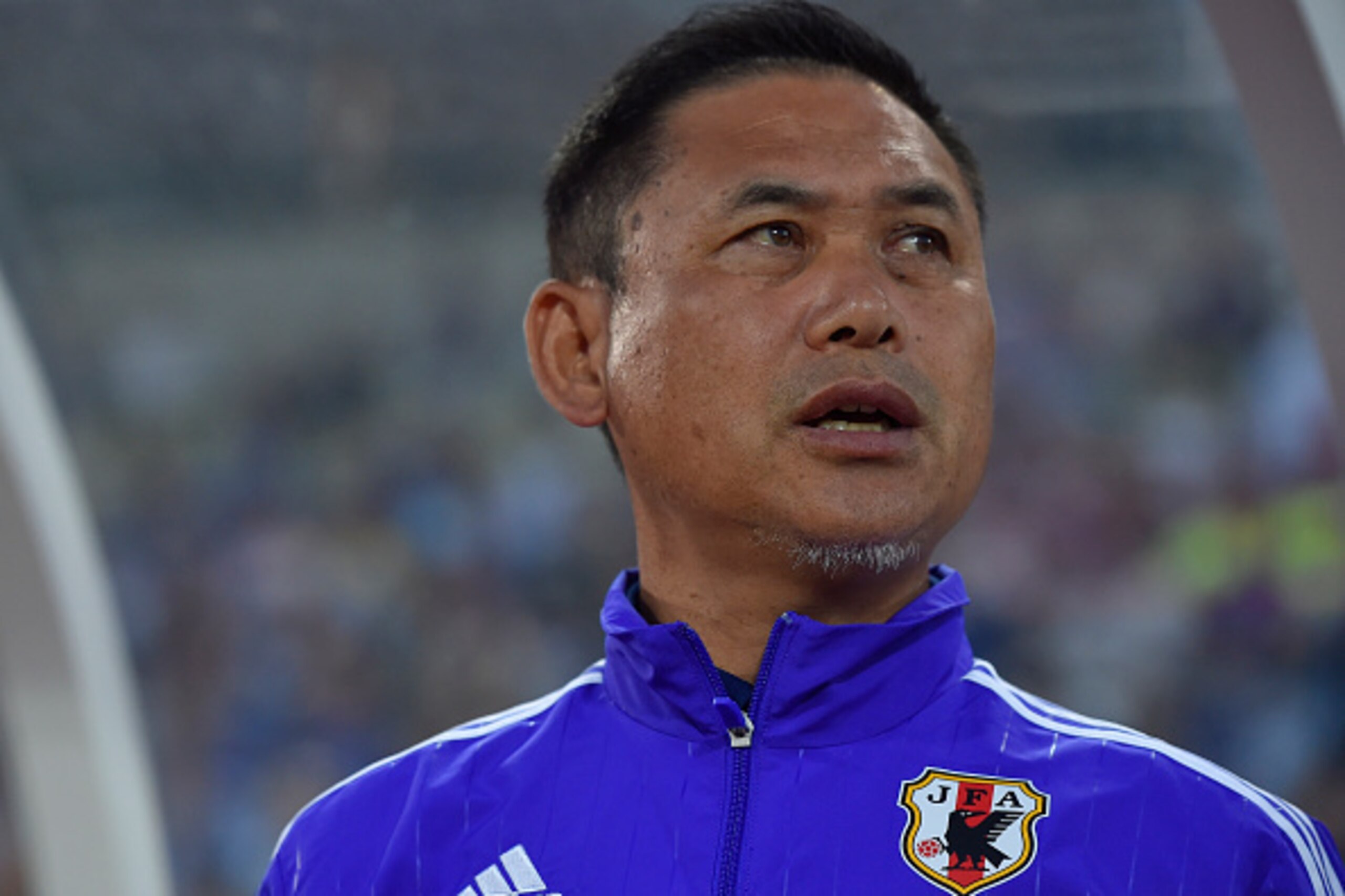 MARUGAME, JAPAN - MAY 24: Head Coach Norio Sasaki of Japan  sings the nationa anthem before the MS&AD Nadeshiko Cup 2015 women's soccer international friendly match between Japan and New Zealand at Kagawa Prefectural Marugame Stadium on May 24, 2015 in Ma
