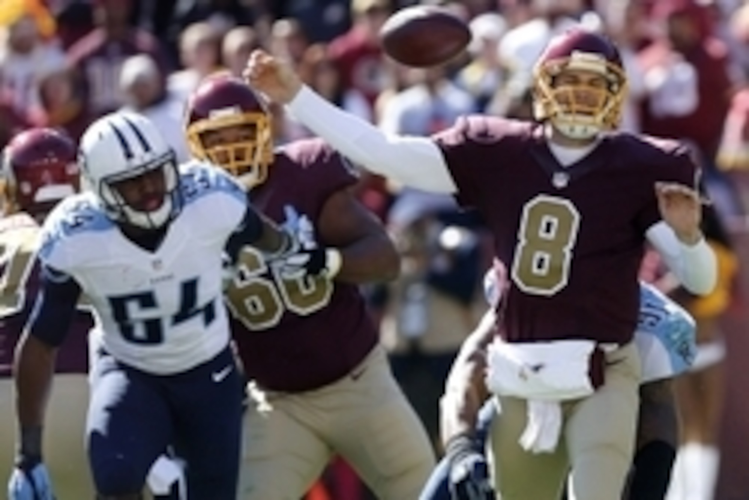 Oct 19, 2014; Landover, MD, USA; Washington Redskins quarterback Kirk Cousins (8) attempts to throw the ball as Tennessee Titans outside linebacker Derrick Morgan (91) tackles him in the first quarter at FedEx Field. Mandatory Credit: Geoff Burke-USA TODA