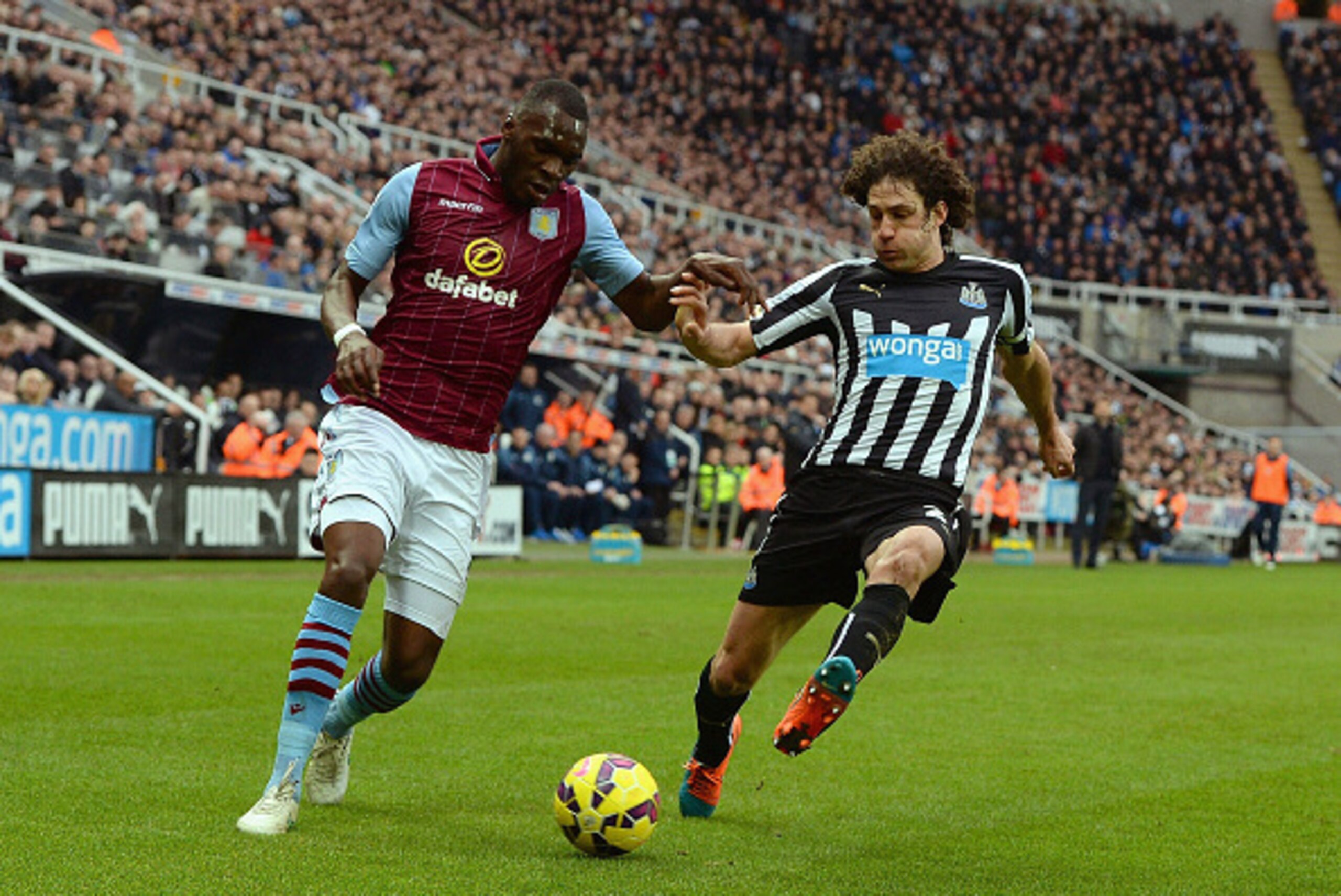 NEWCASTLE UPON TYNE, ENGLAND - FEBRUARY 28:  Christian Benteke of Aston Villa is closed down by Fabricio Coloccini of Newcastle United during the Barclays Premier League match between Newcastle United and Aston Villa at St James' Park on February 28, 2015