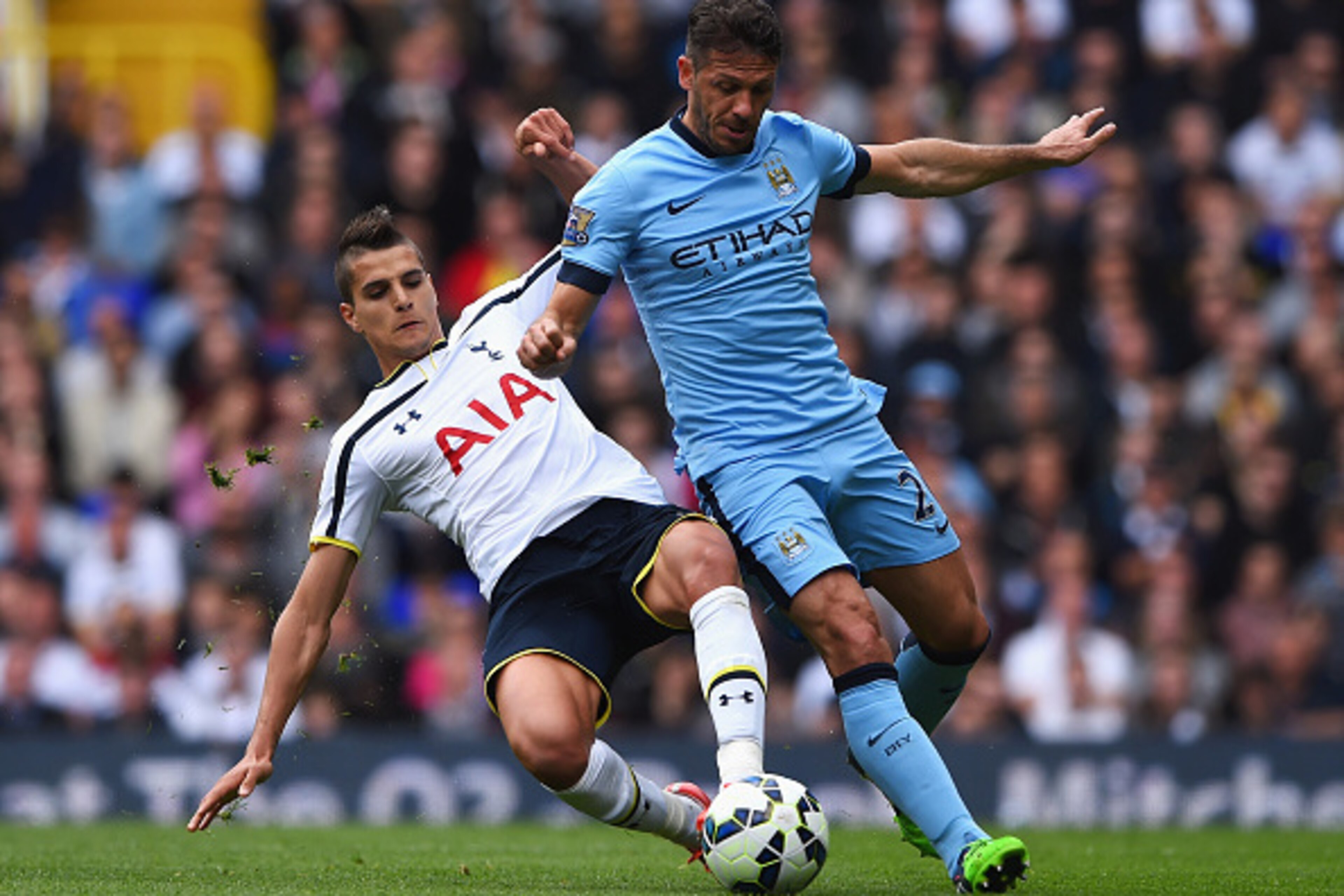LONDON, ENGLAND - MAY 03: Erik Lamela of Tottenham Hotspur tackles Martin Demichelis of Manchester City during the Barclays Premier League match between Tottenham Hotspur and Manchester City at White Hart Lane on May 3, 2015 in London, England.  (Photo by