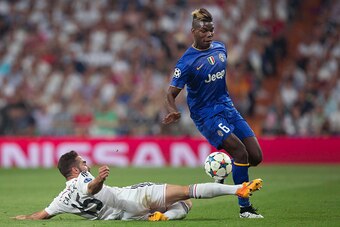 MADRID, SPAIN - MAY 13:  Paul Pogba of Juventus is tackled  by Daniel Carvajal of Real Madrid during the UEFA Champions League Semi Final, second leg match between Real Madrid and Juventus at Estadio Santiago Bernabeu on May 13, 2015 in Madrid, Spain.  (P