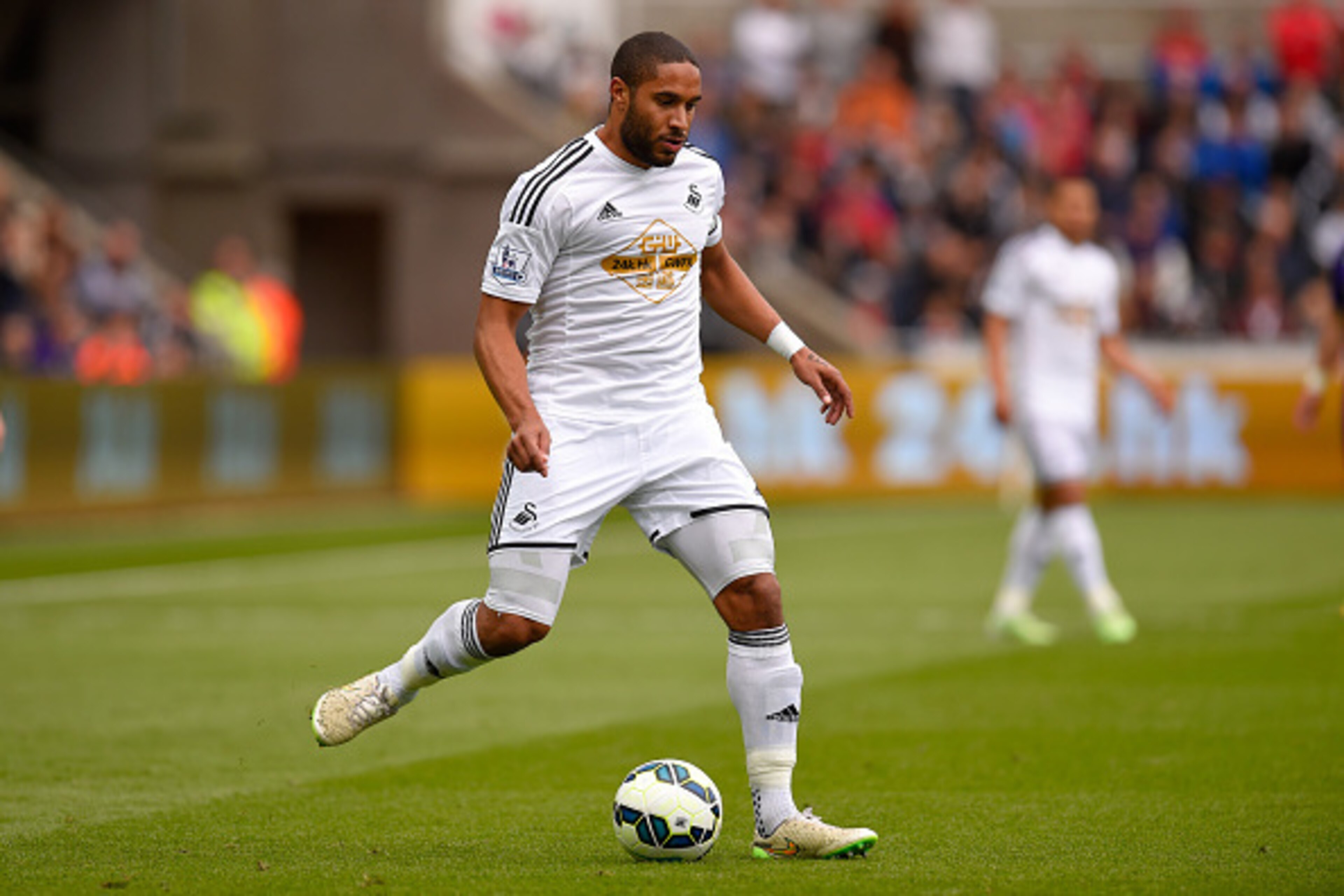 SWANSEA, WALES - MAY 17:  Swansea player Ashley Williams in action during the Barclays Premier League match between Swansea City and Manchester City at Liberty Stadium on May 17, 2015 in Swansea, Wales.  (Photo by Stu Forster/Getty Images)