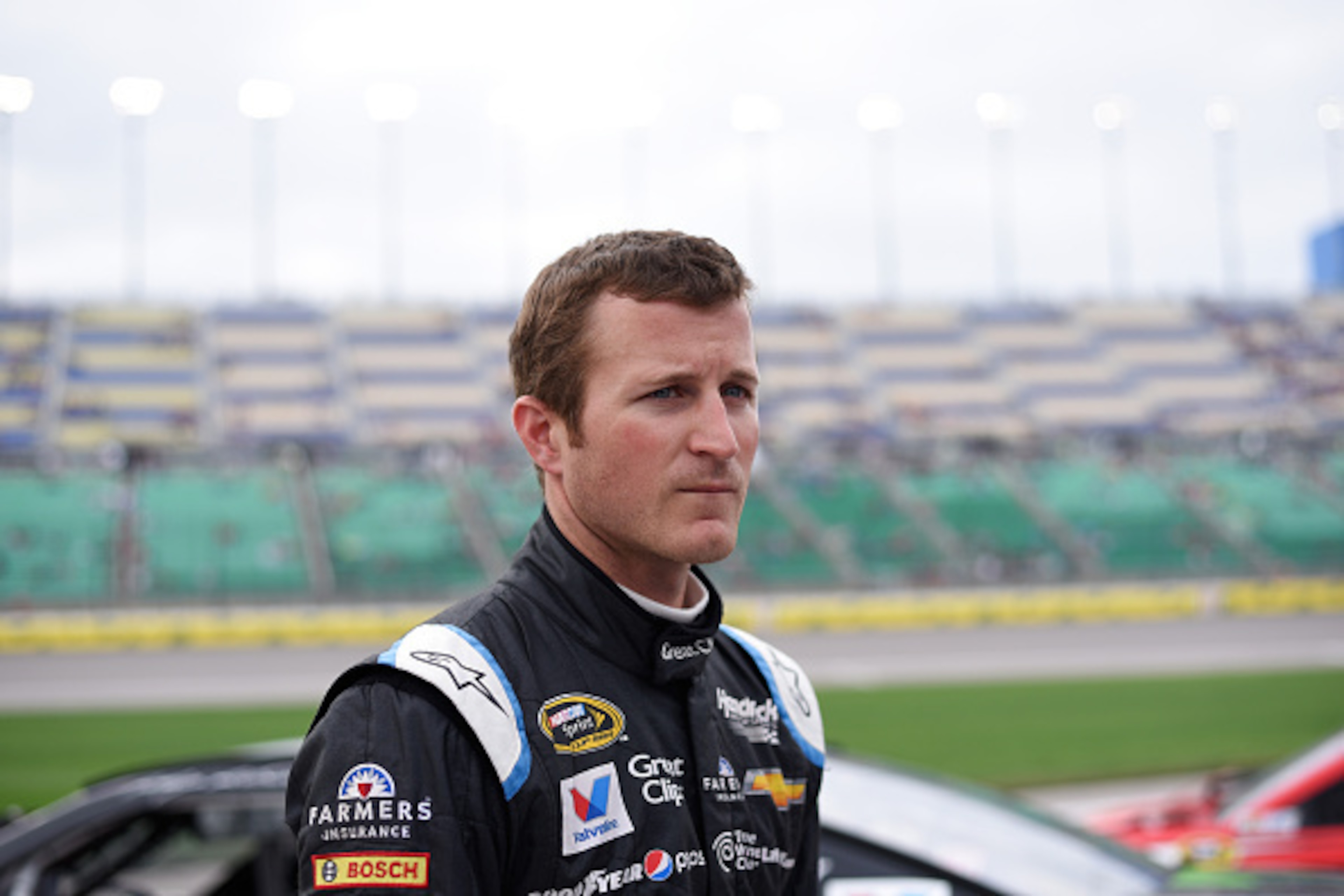 KANSAS CITY, KS - MAY 08: Kasey Kahne, driver of the #5 Great Clips Chevrolet, stands on the grid during qualifying for the NASCAR Sprint Cup Series SpongeBob SquarePants 400 at Kansas Speedway on May 8, 2015 in Kansas City, Kansas.  (Photo by Ed Zurga/Ge