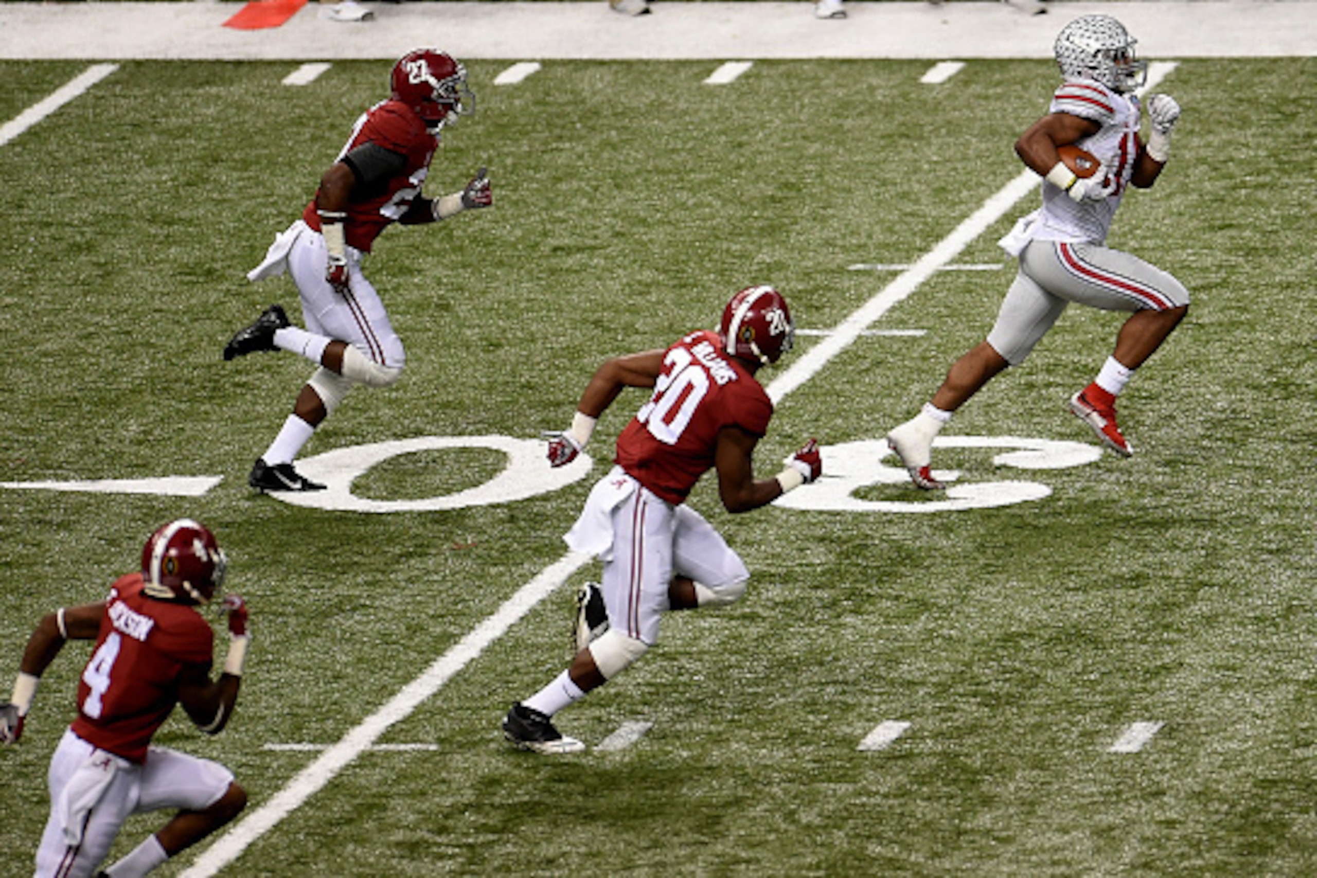 NEW ORLEANS, LA - JANUARY 01:  Ezekiel Elliott #15 of the Ohio State Buckeyes runs the ball against the Alabama Crimson Tide during the All State Sugar Bowl at the Mercedes-Benz Superdome on January 1, 2015 in New Orleans, Louisiana.  (Photo by Stacy Reve