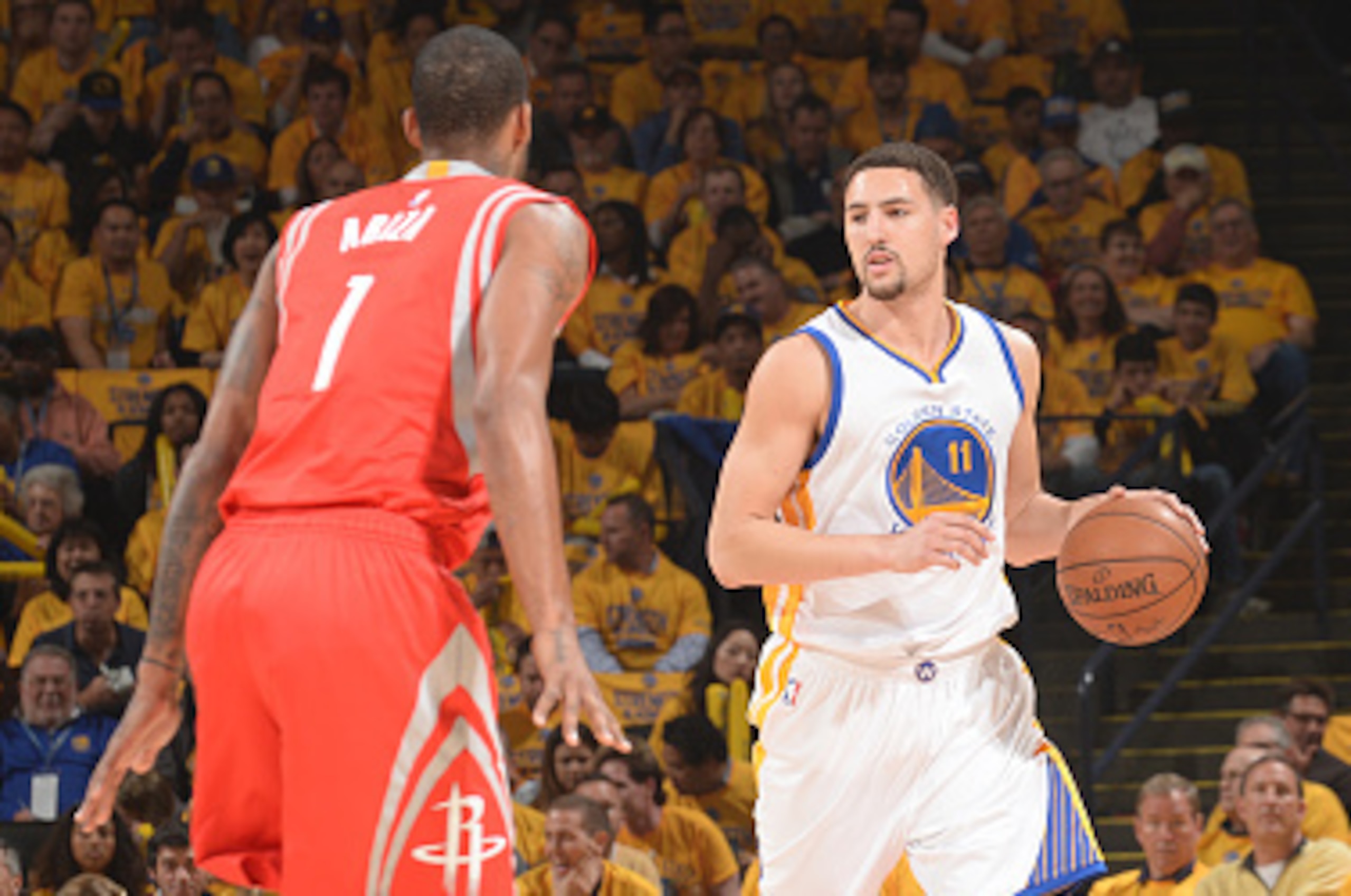 OAKLAND, CA - MAY 19: Klay Thompson #11 of the Golden State Warriors looks to move the ball against Trevor Ariza #1 of the Houston Rockets during Game One of the Western Conference Finals during the NBA Playoffs on May 19, 2015 at ORACLE Arena in Oakland,