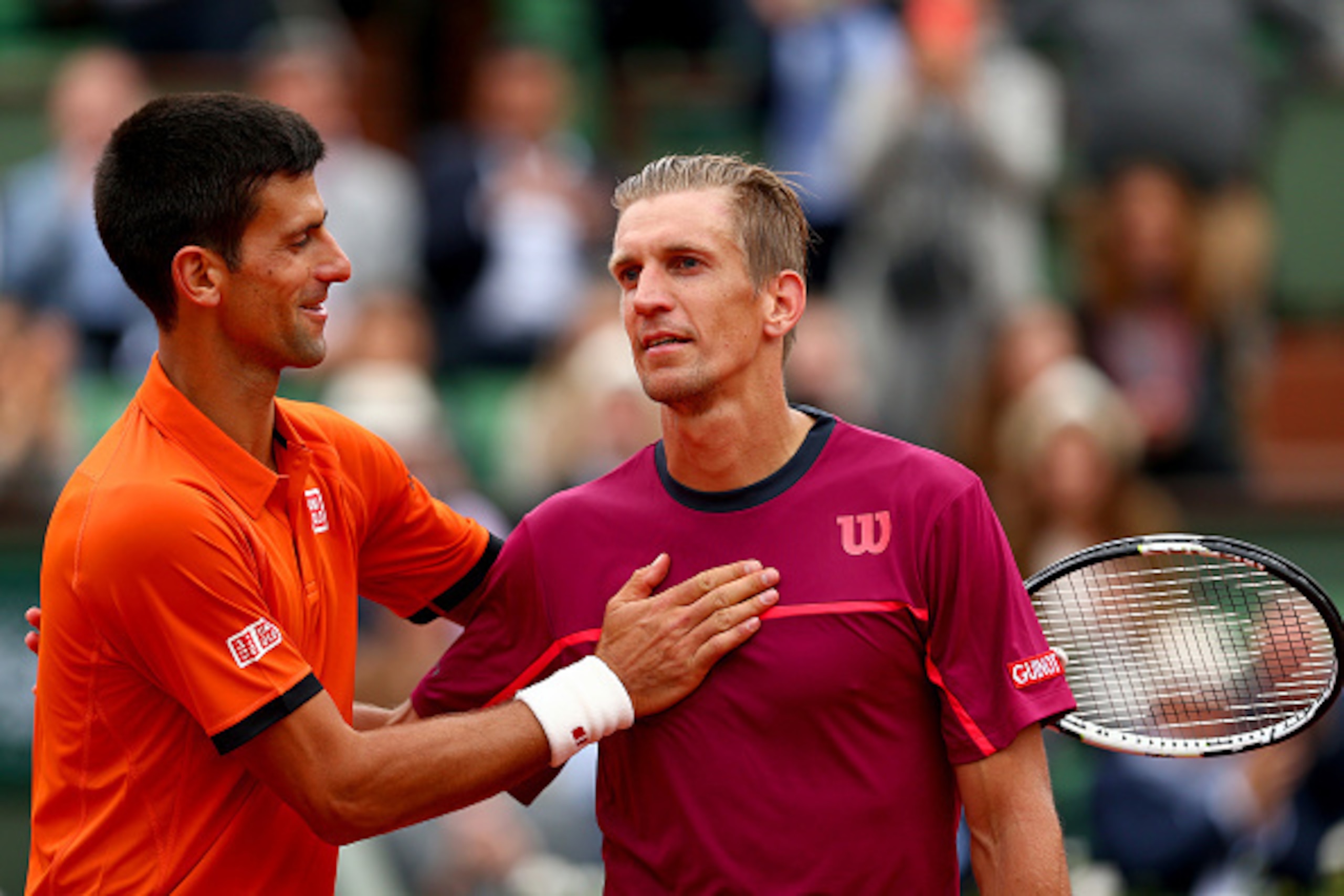 PARIS, FRANCE - MAY 26:  Novak Djokovic of Serbia speaks with Jarkko Nieminen of Finland at the net following his victory in their men's singles match on day three of the 2015 French Open at Roland Garros on May 26, 2015 in Paris, France.  (Photo by Clive