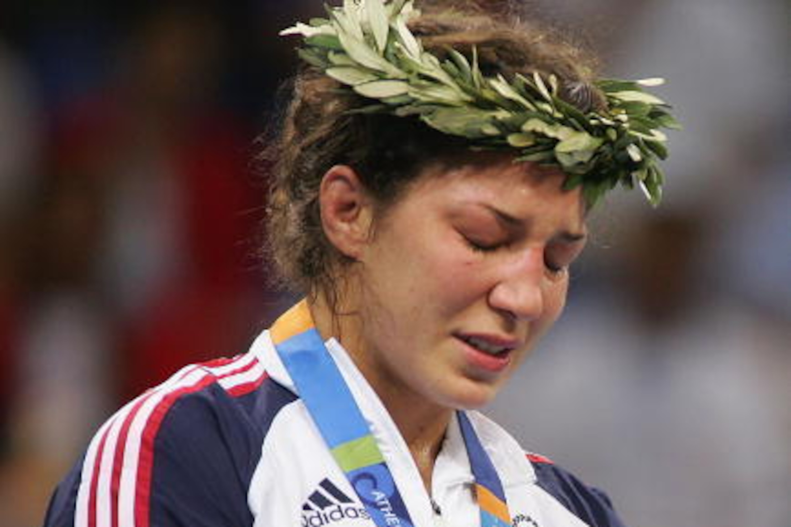 ATHENS - AUGUST 23:  (L-R) An emotional Sara McMann of the USA winner of the Silver medal stands on the podium after the women's Freestyle wrestling 63 kg event on August 23, 2004 during the Athens 2004 Summer Olympic Games at Ano Liossia Olympic Hall in 
