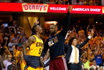 CLEVELAND, OH - MAY 26: J.R. Smith #5, LeBron James #23 and Anderson Varejao #17 of the Cleveland Cavaliers celebrate late in the fourth quarter against the Atlanta Hawks during Game Four of the Eastern Conference Finals of the 2015 NBA Playoffs at Quicke