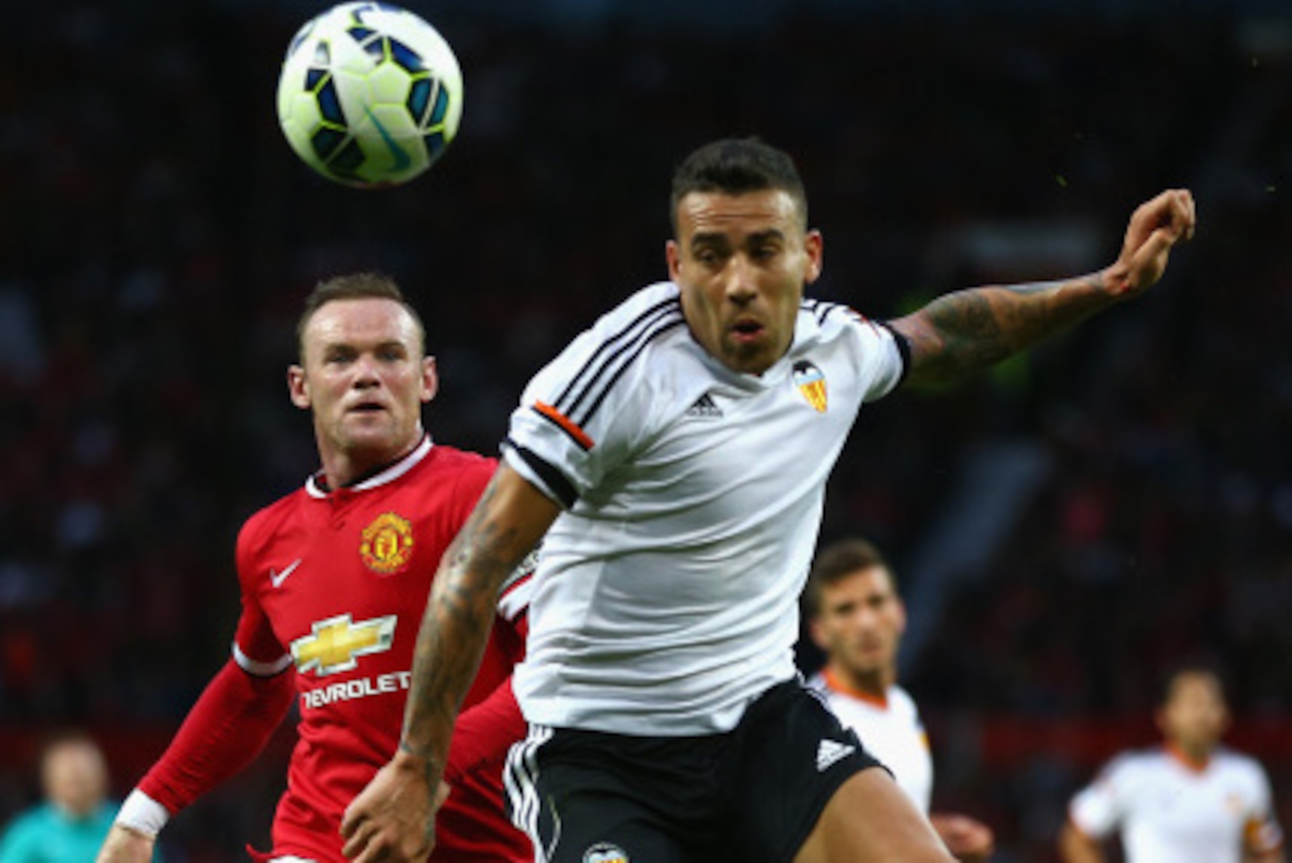 MANCHESTER, ENGLAND - AUGUST 12: Wayne Rooney of Manchester United in action with  Nicolas Otamendi of Valencia during the Pre Season Friendly match between Manchester United and Valencia at Old Trafford on August 12, 2014 in Manchester, England.  (Photo 
