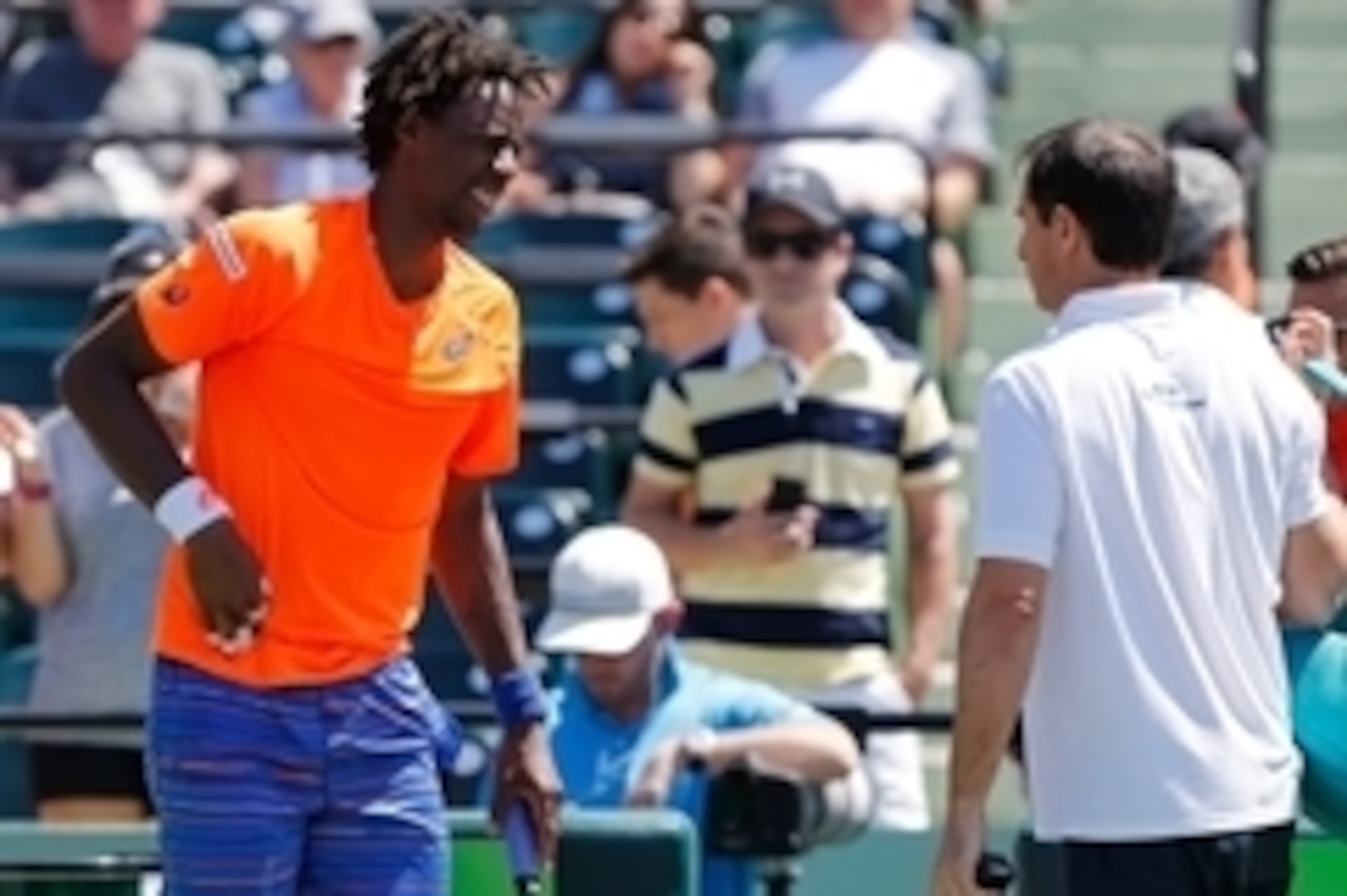Mar 31, 2015; Key Biscayne, FL, USA; Gael Monfils talks to an ATP trainer after suffering an apparent injury against Tomas Berdych (not pictured) on day nine of the Miami Open at Crandon Park Tennis Center. Berdych won 6-3, 3-2 (ret.). Mandatory Credit: G