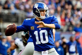 EAST RUTHERFORD, NJ - DECEMBER 28:  Eli Manning #10 of the New York Giants passes against the Philadelphia Eagles in the first quarter during a game at MetLife Stadium on December 28, 2014 in East Rutherford, New Jersey.  (Photo by Alex Goodlett/Getty Ima