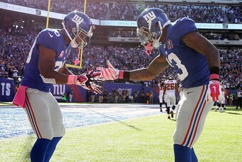 EAST RUTHERFORD, NJ - OCTOBER 05:  Wide receiver Odell Beckham #13 of the New York Giants celebrates with wide receiver Victor Cruz #80 after scoring a 15 yard touchdown in the fourth quarter against the Atlanta Falcons during their game at MetLife Stadiu