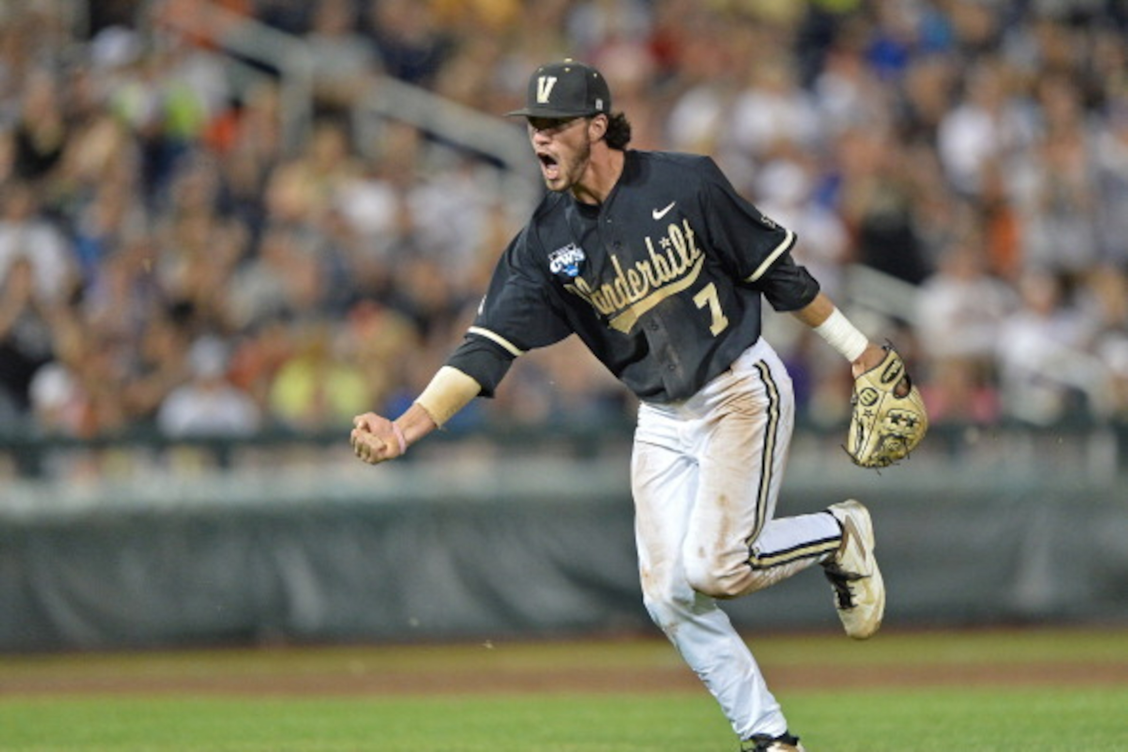 Omaha, NE - JUNE 25:  Second basemen Dansby Swanson #7 of the Vanderbilt Commodores celebrates after recording the final out of the eighth inning against the Virginia Cavaliers during game three of the College World Series Championship Series on June 25, 