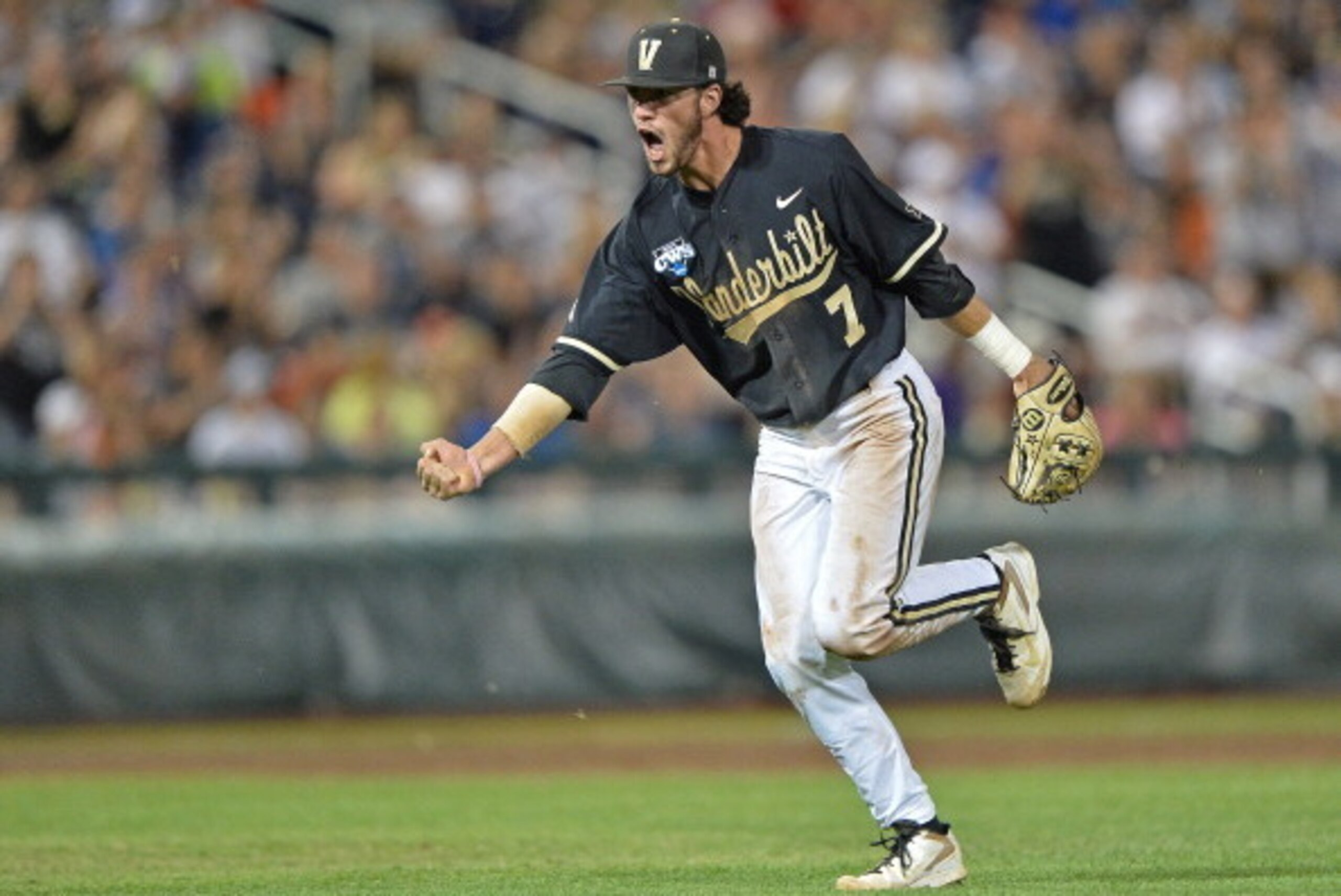 Omaha, NE - JUNE 25:  Second basemen Dansby Swanson #7 of the Vanderbilt Commodores celebrates after recording the final out of the eighth inning against the Virginia Cavaliers during game three of the College World Series Championship Series on June 25, 