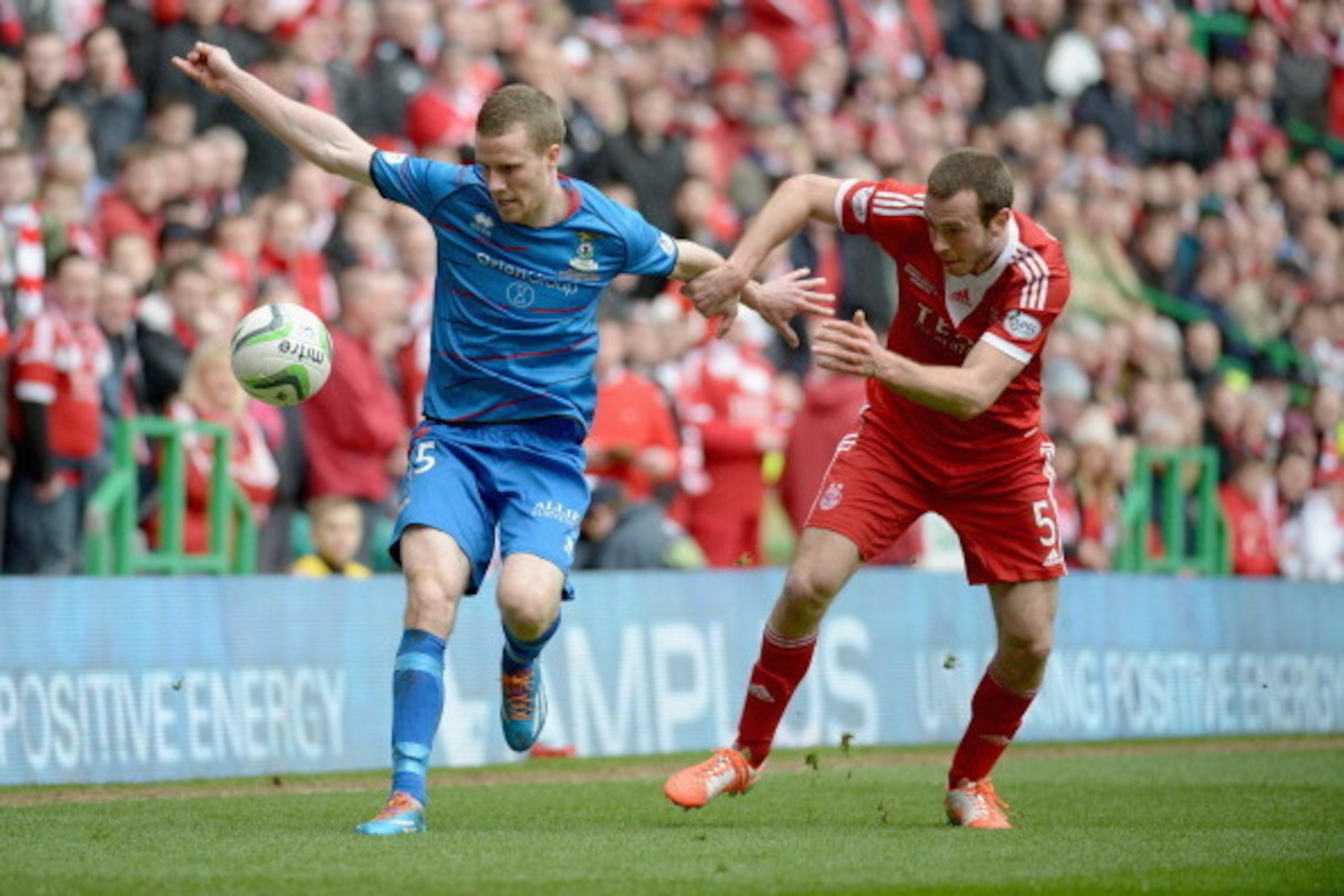 GLASGOW, SCOTLAND - MARCH 16:  Andrew Considine of Aberdeen tackles Marley Watkins of Caledonian Thistle during the Scottish Communities League Cup Final at Celtic Park Stadium between Aberdeen and Caledonian Thistle on March 16, 2014 in Glasgow, Scotland