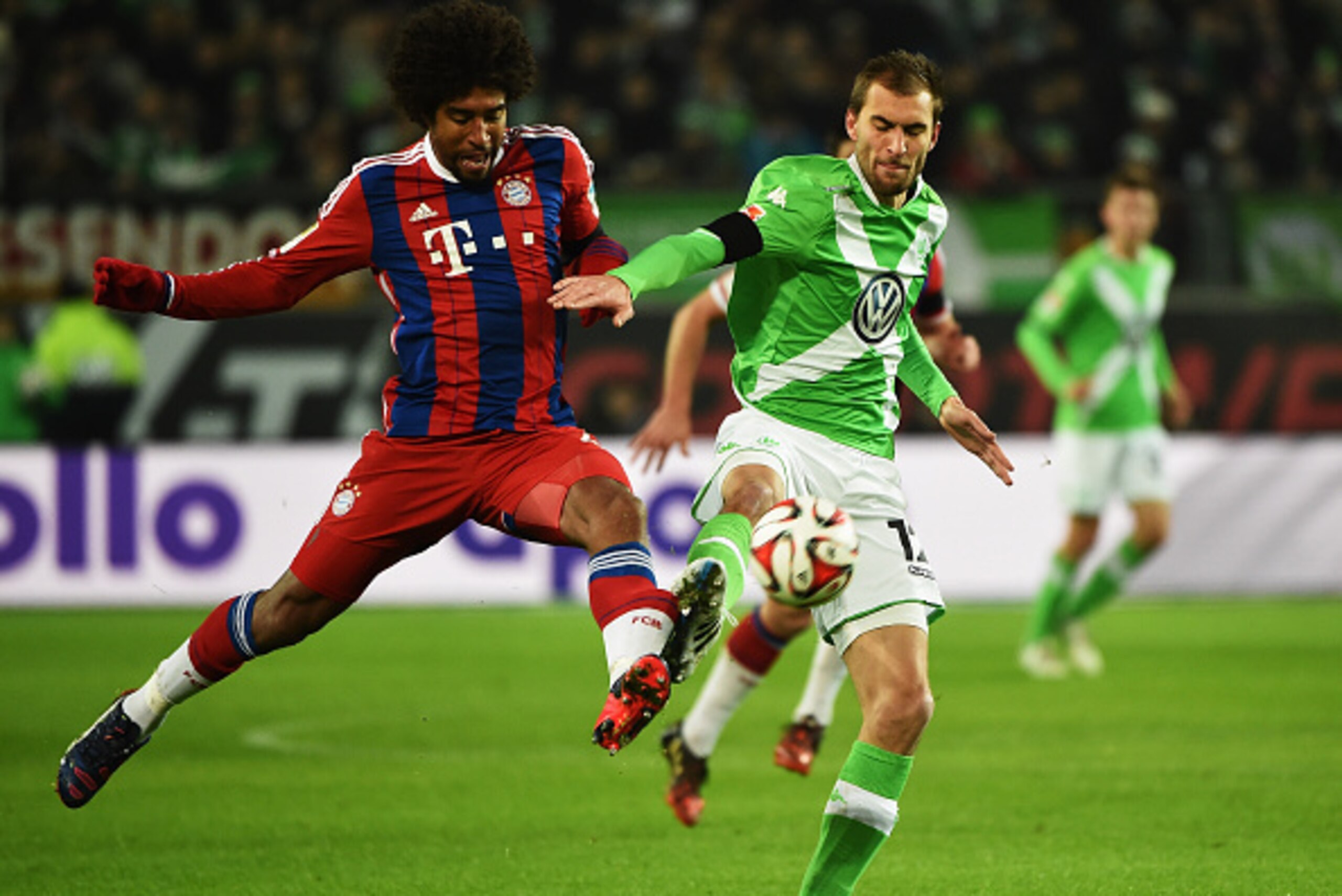 WOLFSBURG, GERMANY - JANUARY 30:  Dante of Muenchen is challenged by Bas Dost of Wolfsburg during the Bundesliga match between VfL Wolfsburg and FC Bayern Muenchen at Volkswagen Arena on January 30, 2015 in Wolfsburg, Germany.  (Photo by Stuart Franklin/G