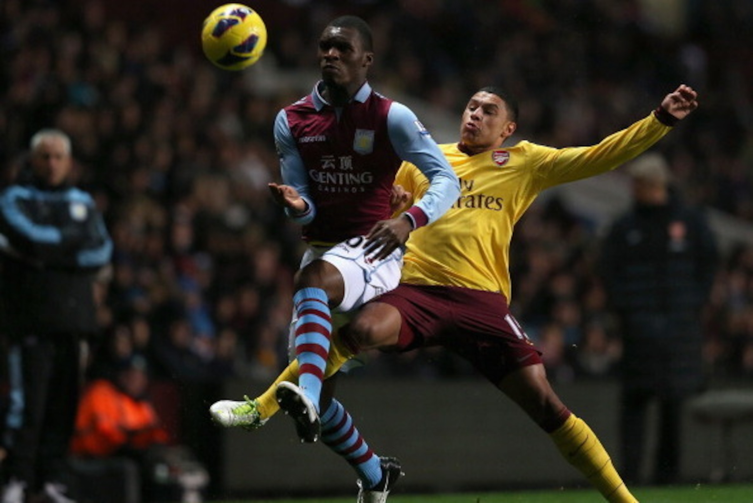 BIRMINGHAM, ENGLAND - NOVEMBER 24:  Christian Benteke of Aston Villa and Alex Oxlade-Chamberlain of Arsenal battle for the ball during the Barclays Premier League match between Aston Villa and Arsenal at Villa Park on November 24, 2012 in Birmingham, Engl
