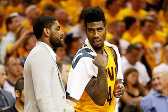 CLEVELAND, OH - MAY 24:  An injured Kyrie Irving #2 talks to Iman Shumpert #4 of the Cleveland Cavaliers on the bench in the first half against the Atlanta Hawks during Game Three of the Eastern Conference Finals of the 2015 NBA Playoffs at Quicken Loans 