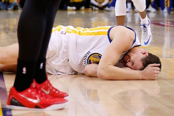 OAKLAND, CA - MAY 27:  Klay Thompson #11 of the Golden State Warriors is injured in the fourth quarter against the Houston Rockets during game five of the Western Conference Finals of the 2015 NBA Playoffs at ORACLE Arena on May 27, 2015 in Oakland, Calif