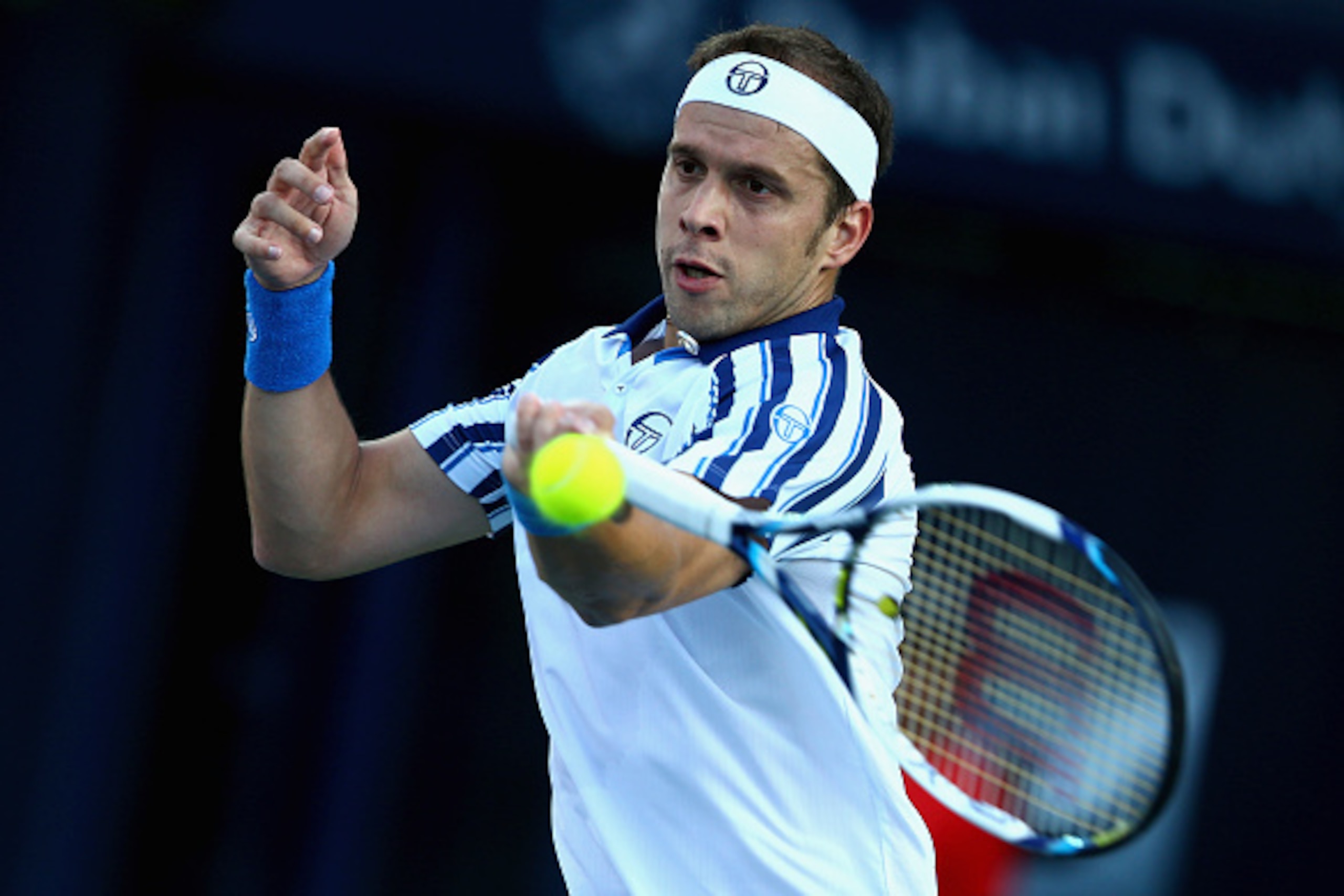 DUBAI, UNITED ARAB EMIRATES - FEBRUARY 24:  Gilles Muller of Luxembourg  in action against  Andy Murray of Great Britain during day two of the ATP Dubai Duty Free Tennis Championships at the Dubai Duty Free Stadium on February 24, 2015 in Dubai, United Ar