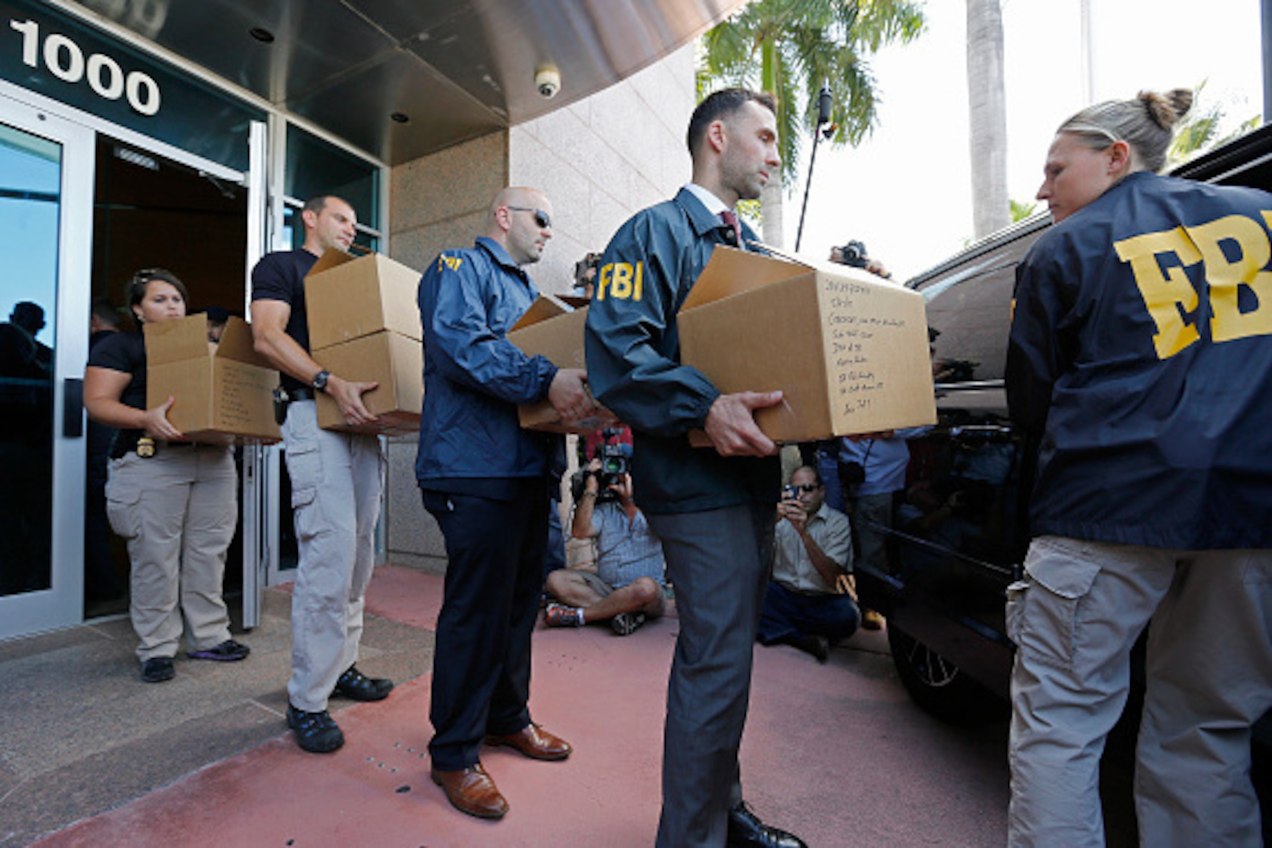 MIAMI BEACH, FL - MAY 27:  FBI agents carry boxes from the headquarters of CONCACAF after it was raided on May 27, 2015 in Miami Beach, Florida. The raid is part of an international investigation of FIFA where nine FIFA officials and five corporate execut