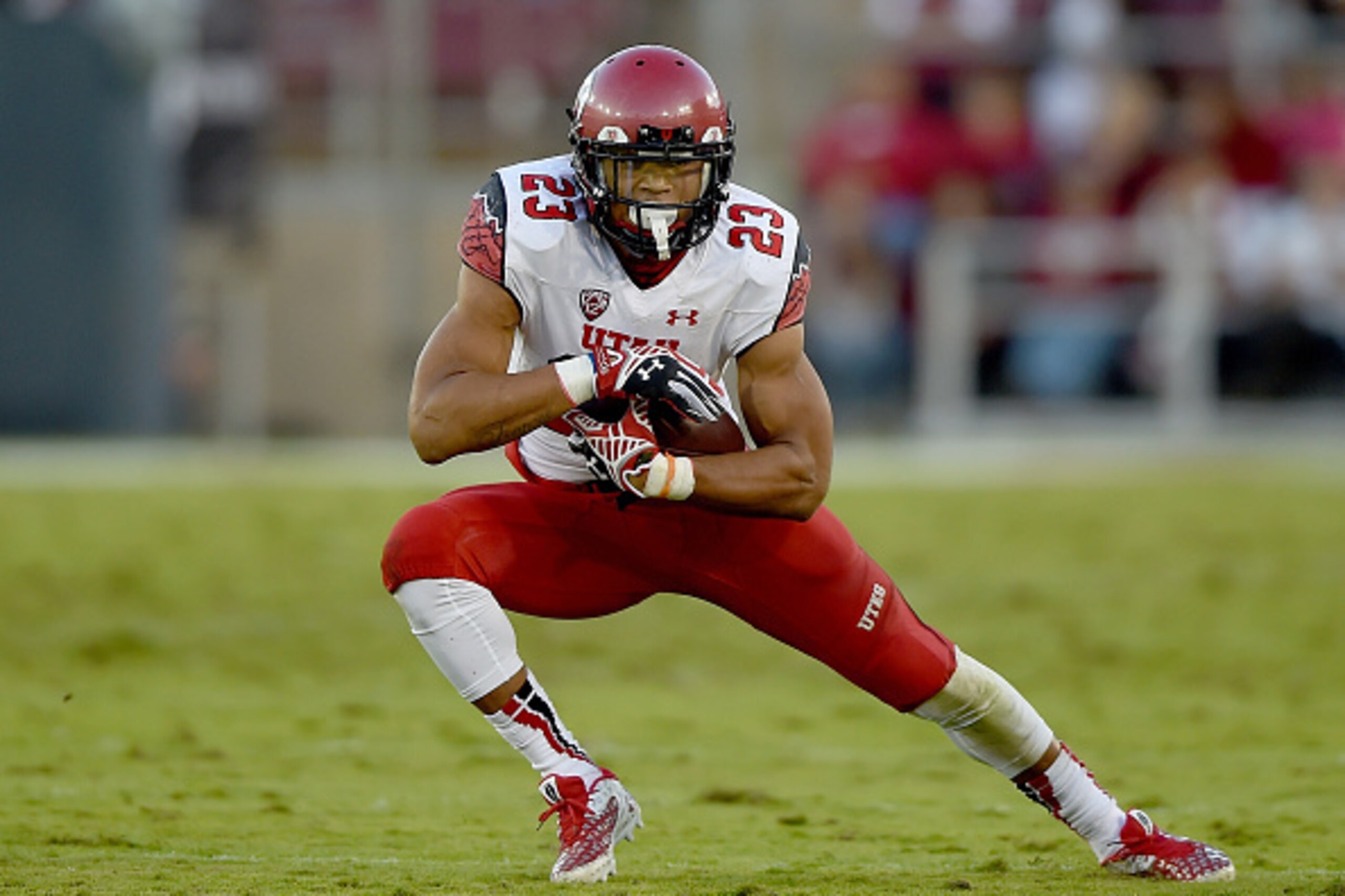 PALO ALTO, CA - NOVEMBER 15:  Devontae Booker #23 of the Utah Utes carries the ball against the Stanford Cardinal in the second quarter at Stanford Stadium on November 15, 2014 in Palo Alto, California.  (Photo by Thearon W. Henderson/Getty Images)