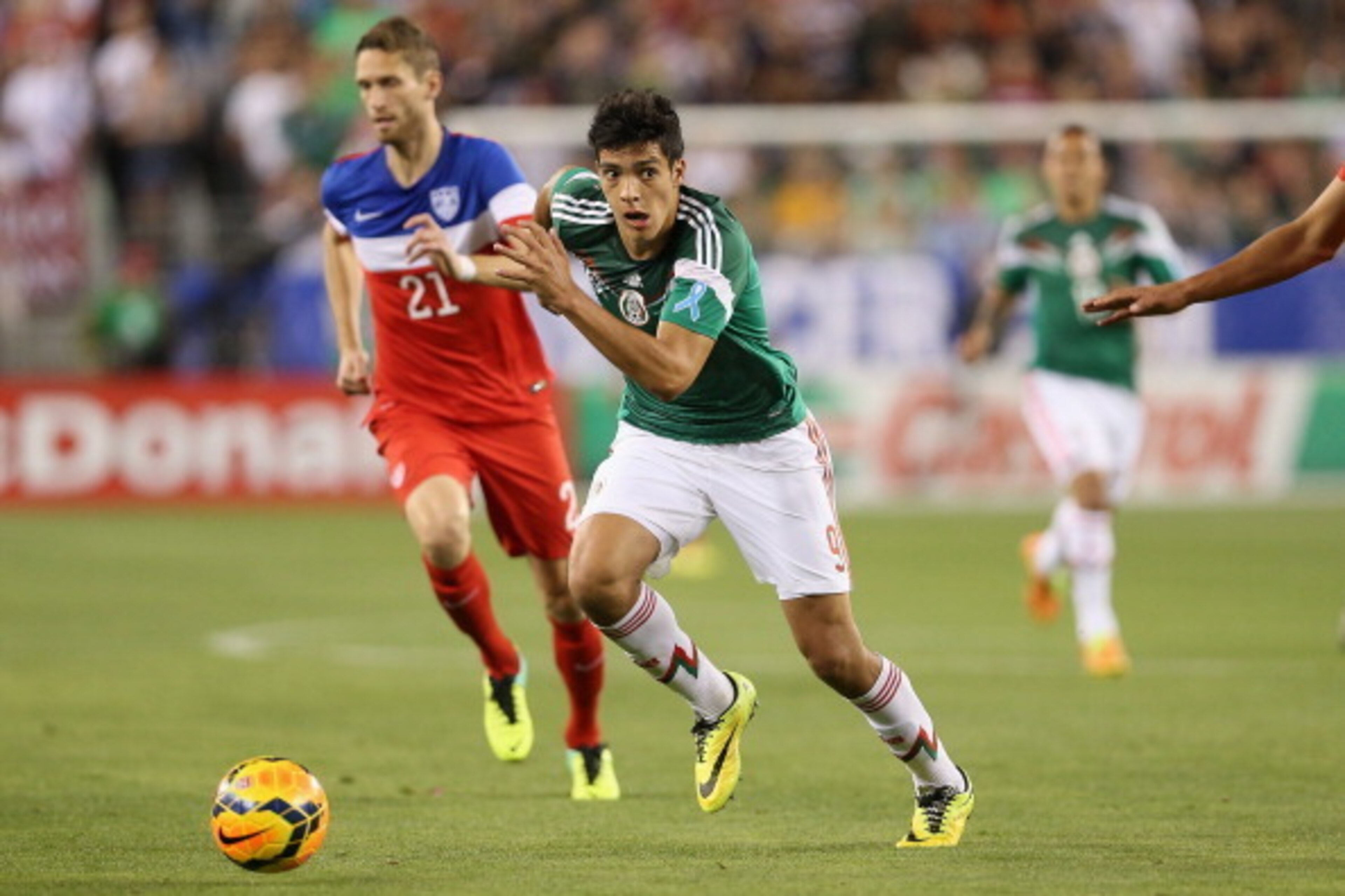 GLENDALE, AZ - APRIL 02:  Raul Jimenez #9 of Mexico controls the ball past Clarence Goodson #21 of USA during the International Friendly at University of Phoenix Stadium on April 2, 2014 in Glendale, Arizona. Mexico and USA played to a 2-2 tie.  (Photo by