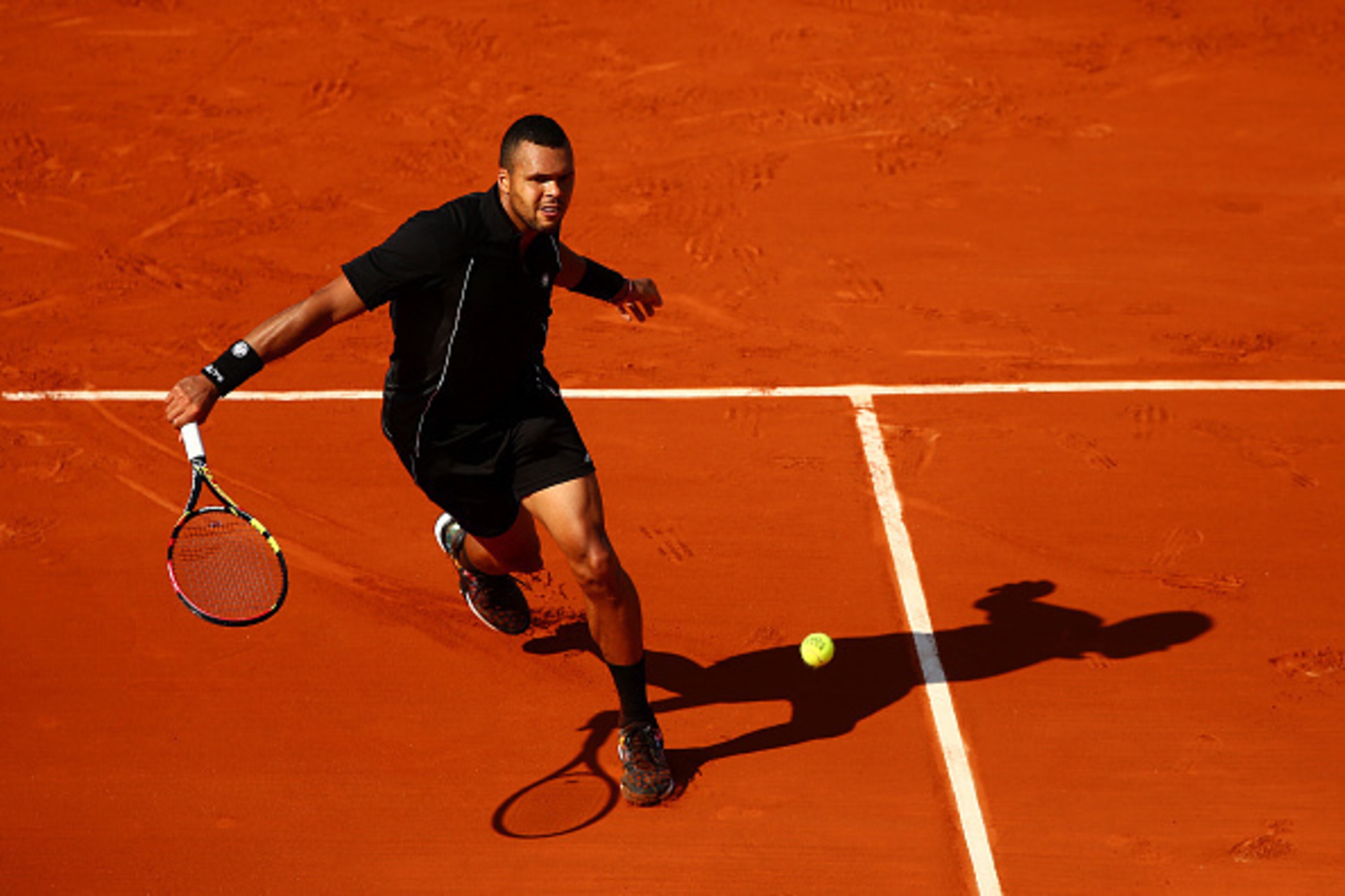 PARIS, FRANCE - MAY 27: Jo-Wilfried Tsonga of France returns a shot in his Men's Singles match against Dudi Sela of Israel during day four of the 2015 French Open at Roland Garros on May 27, 2015 in Paris, France. (Photo by Clive Mason/Getty Images) PARIS, FRANCE - MAY 27: Jo-Wilfried Tsonga of France returns a shot in his Men's Singles match against Dudi Sela of Israel during day four of the 2015 French Open at Roland Garros on May 27, 2015 in Paris, France. (Photo by Clive Mason/Getty Images)
