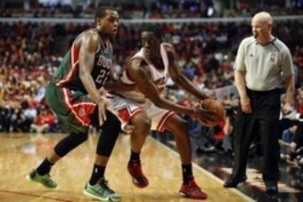 Apr 27, 2015; Chicago, IL, USA; Chicago Bulls forward Tony Snell (20) is defended by Milwaukee Bucks guard Khris Middleton (22) in game five of the first round of the 2015 NBA Playoffs at United Center. The Bucks won 94-88. Mandatory Credit: Kamil Krzaczy