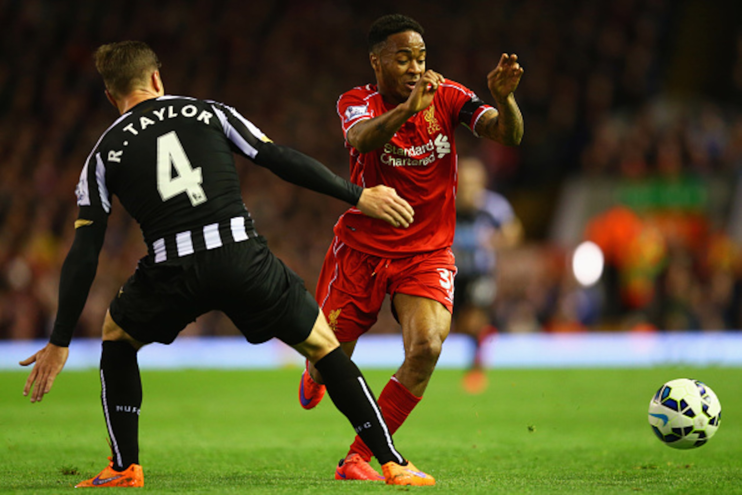 LIVERPOOL, ENGLAND - APRIL 13:  Raheem Sterling of Liverpool takes on Ryan Taylor of Newcastle United during the Barclays Premier League match between Liverpool and Newcastle United at Anfield on April 13, 2015 in Liverpool, England.  (Photo by Clive Brun