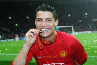 MOSCOW - MAY 21:  Cristiano Ronaldo of Manchester United bites his winners medal following his team's victory during the UEFA Champions League Final match between Manchester United and Chelsea at the Luzhniki Stadium on May 21, 2008 in Moscow, Russia.  (P