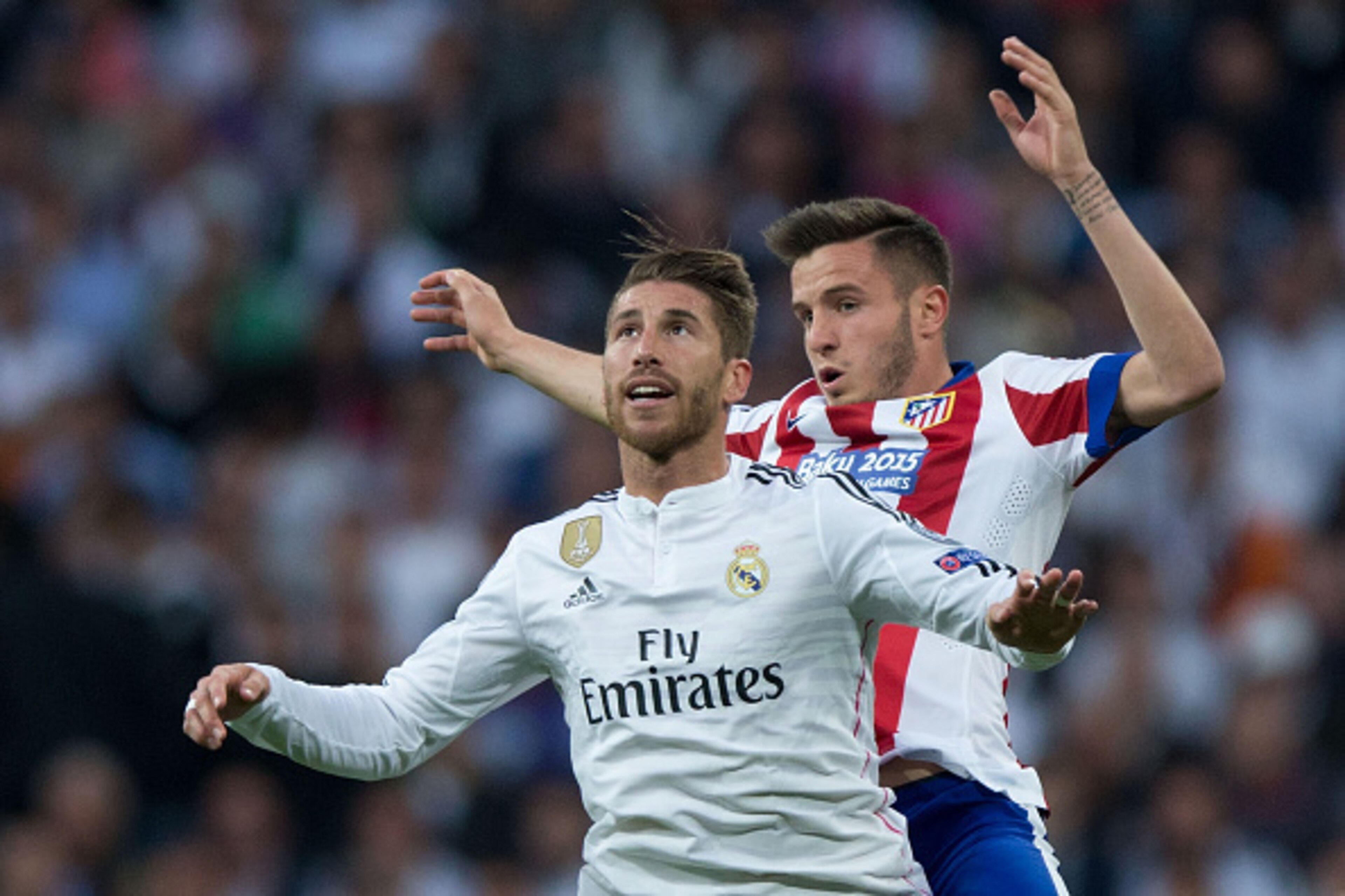 MADRID, SPAIN - APRIL 22: Sergio Ramos of Real Madrid CF jumps for the ball ahead Saul Niguez of Atletico de Madrid during the UEFA Champions League quarter-final second leg match between Real Madrid CF and Club Atletico de Madrid at Bernabeu on April 22,