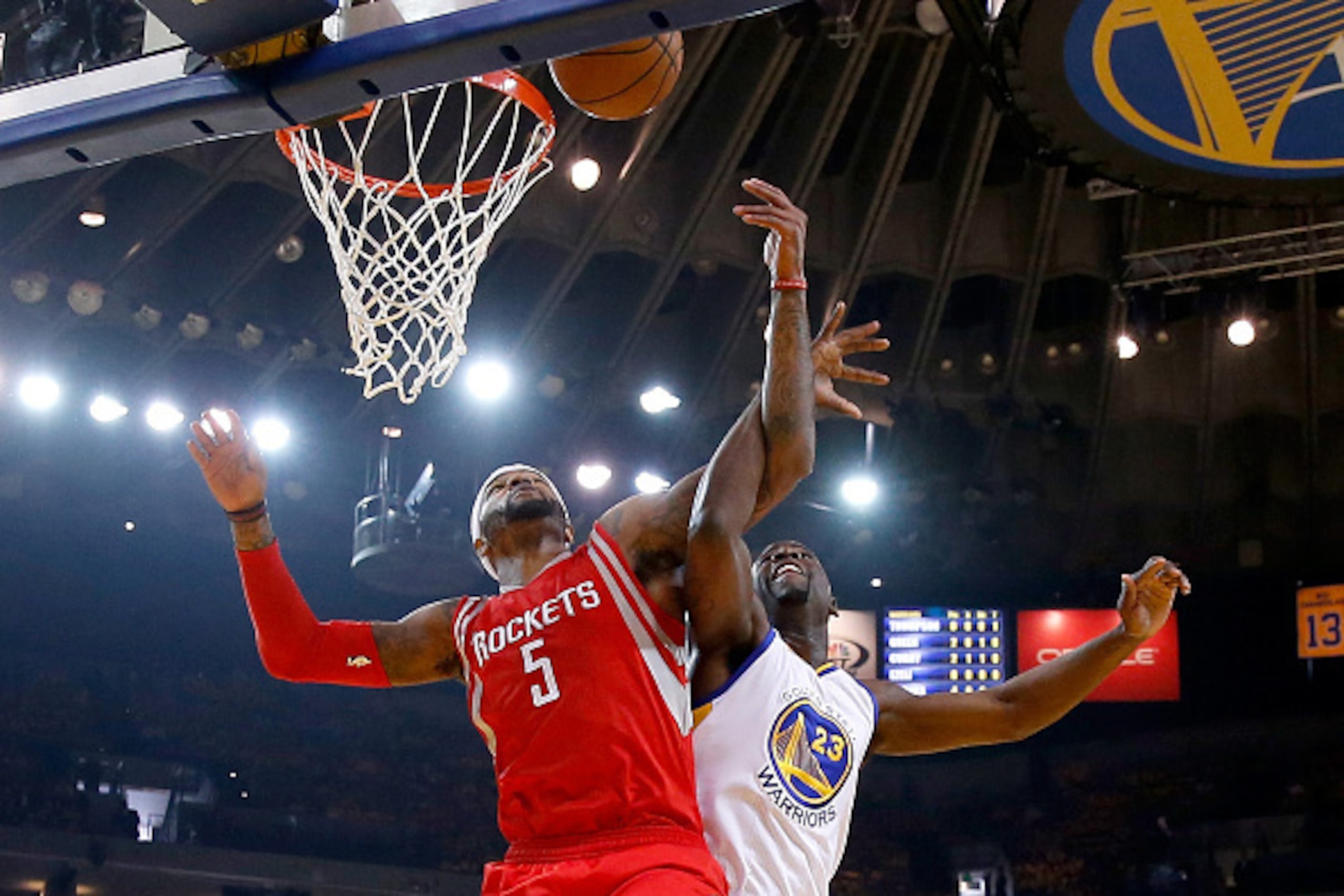 OAKLAND, CA - MAY 27:  Josh Smith #5 of the Houston Rockets goes up for the ball alongside Draymond Green #23 of the Golden State Warriors in the first half during game five of the Western Conference Finals of the 2015 NBA Playoffs at ORACLE Arena on May 