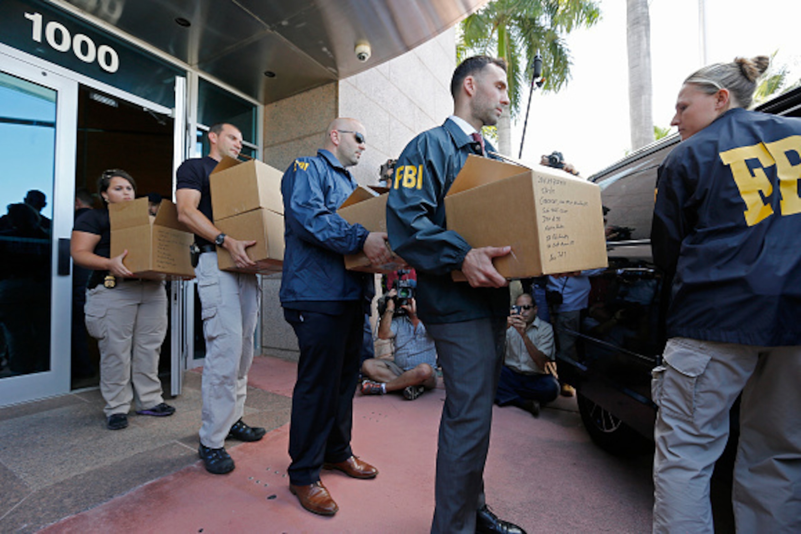 MIAMI BEACH, FL - MAY 27:  FBI agents carry boxes from the headquarters of CONCACAF after it was raided on May 27, 2015 in Miami Beach, Florida. The raid is part of an international investigation of FIFA where nine FIFA officials and five corporate execut