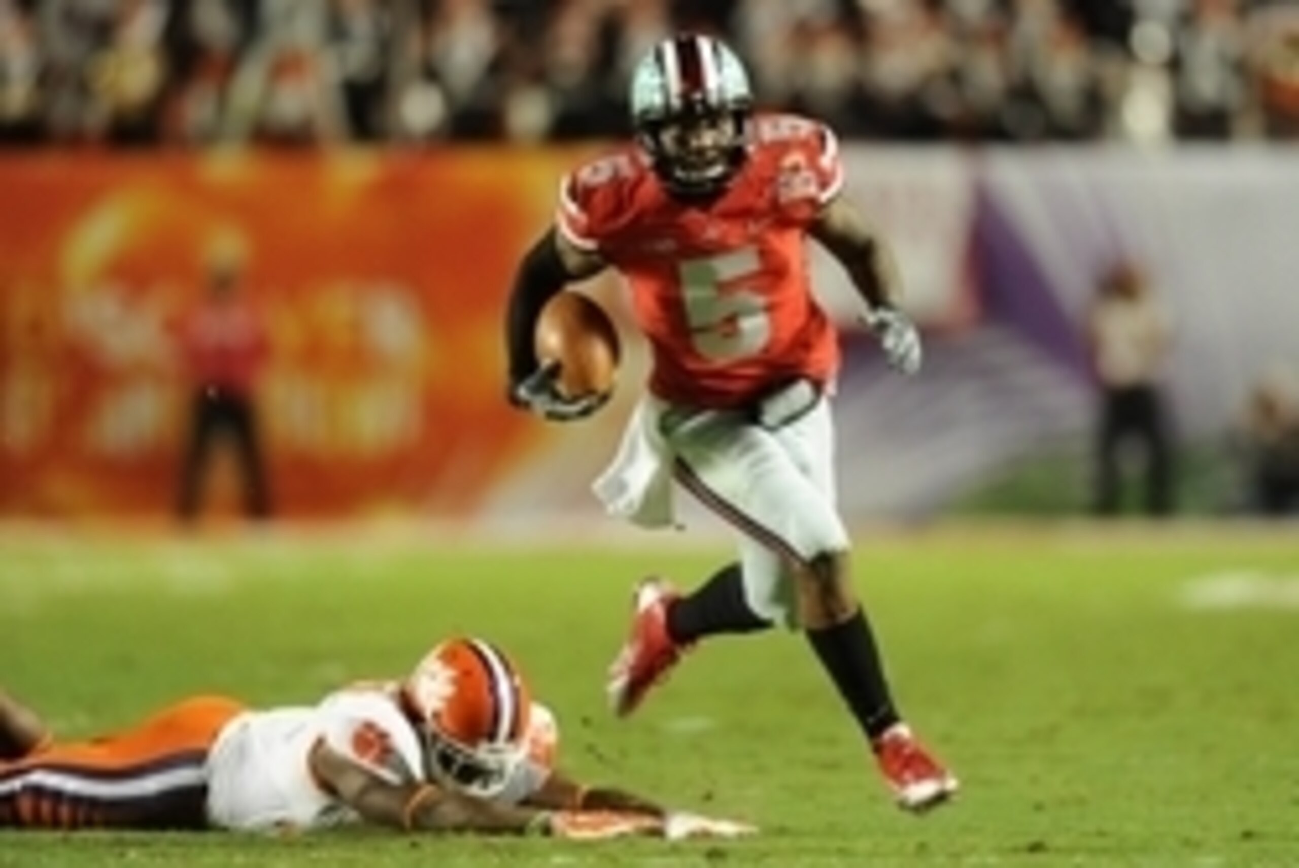 Jan 3, 2014; Miami Gardens, FL, USA; Ohio State Buckeyes quarterback Braxton Miller (5) runs past Clemson Tigers safety Robert Smith (27) for a touchdown in the first half during the 2014 Orange Bowl college football game at Sun Life Stadium. Mandatory Cr Jan 3, 2014; Miami Gardens, FL, USA; Ohio State Buckeyes quarterback Braxton Miller (5) runs past Clemson Tigers safety Robert Smith (27) for a touchdown in the first half during the 2014 Orange Bowl college football game at Sun Life Stadium. Mandatory Cr