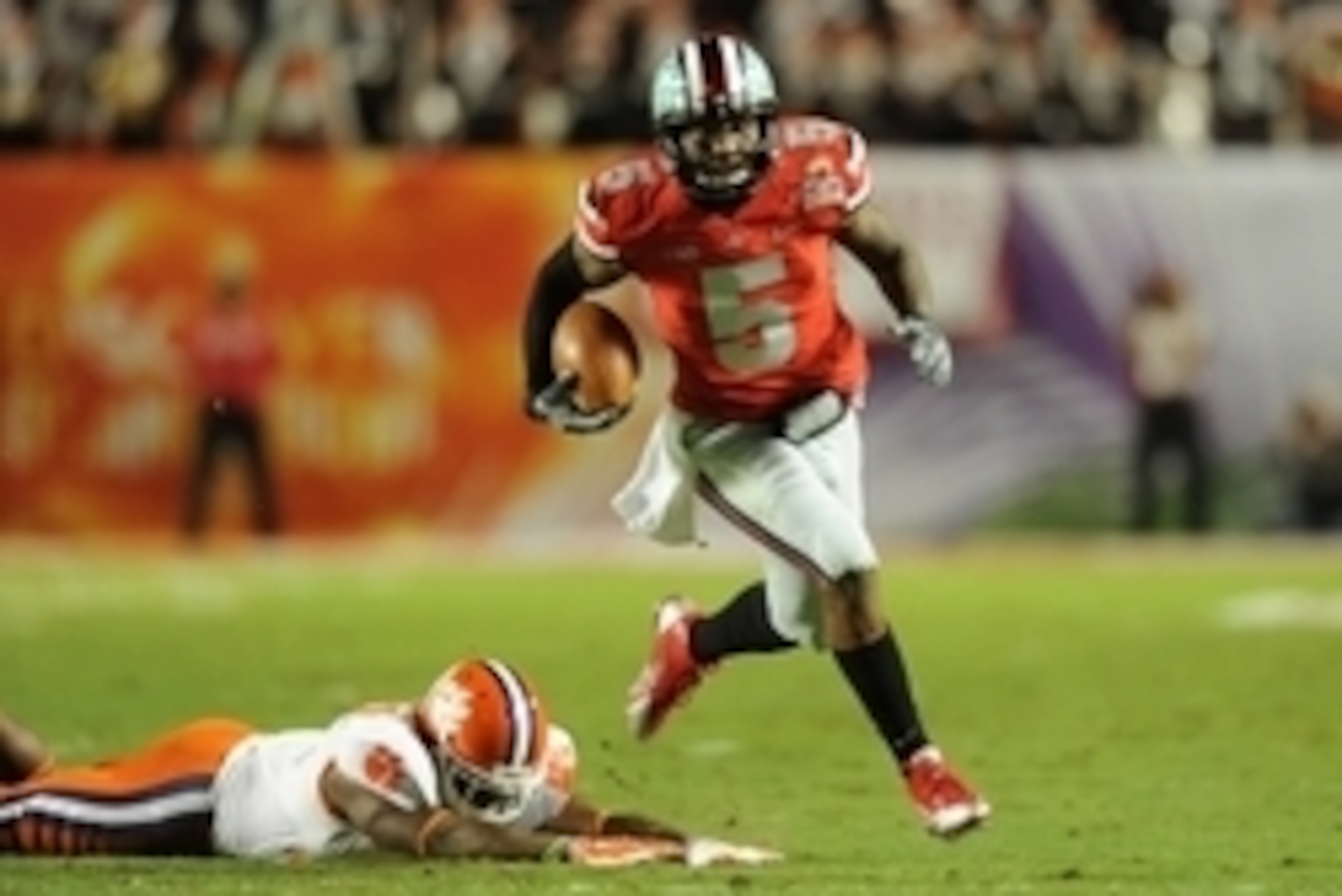 Jan 3, 2014; Miami Gardens, FL, USA; Ohio State Buckeyes quarterback Braxton Miller (5) runs past Clemson Tigers safety Robert Smith (27) for a touchdown in the first half during the 2014 Orange Bowl college football game at Sun Life Stadium. Mandatory Cr