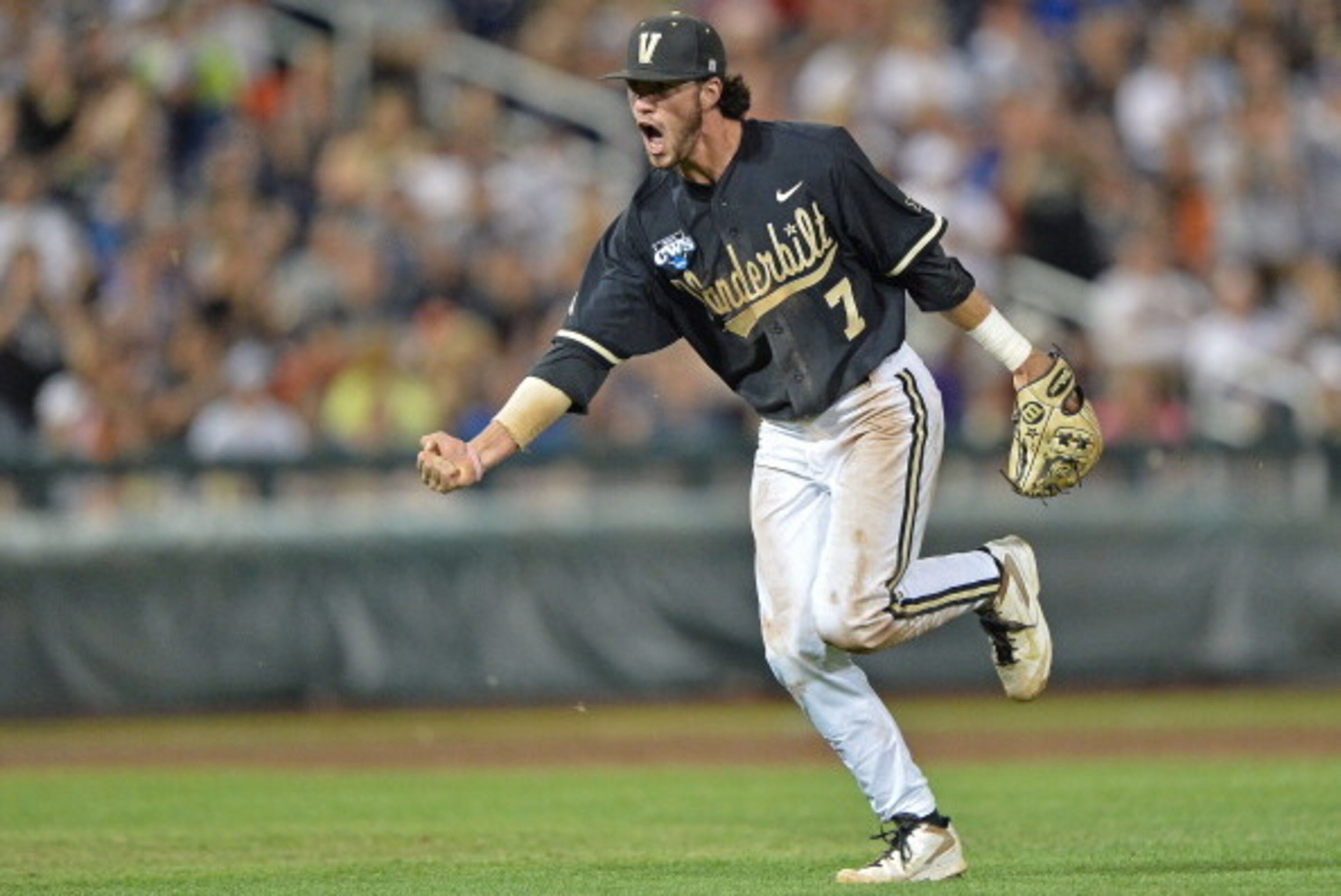 Omaha, NE - JUNE 25:  Second basemen Dansby Swanson #7 of the Vanderbilt Commodores celebrates after recording the final out of the eighth inning against the Virginia Cavaliers during game three of the College World Series Championship Series on June 25, 
