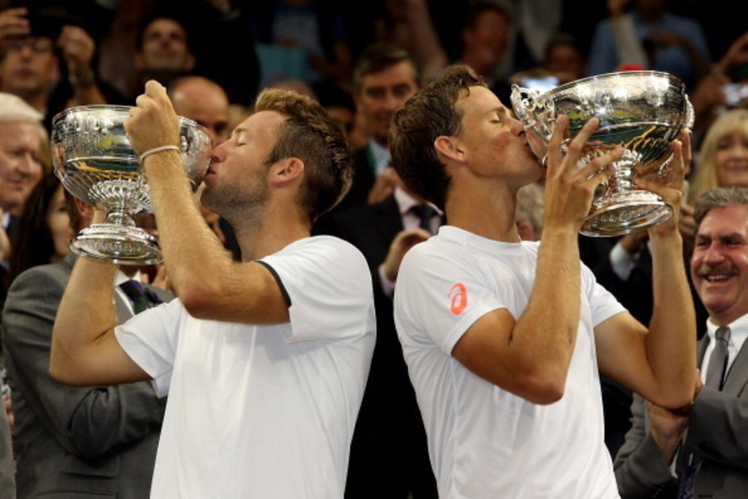 LONDON, ENGLAND - JULY 05:  Jack Sock of the United States (l) and Vasek Pospisil of Canada celebrate by kissing the winner trophies after winning the Gentlemen's Doubles Final against Bob Bryan and Mike Bryan of the United States on day twelve of the Wim