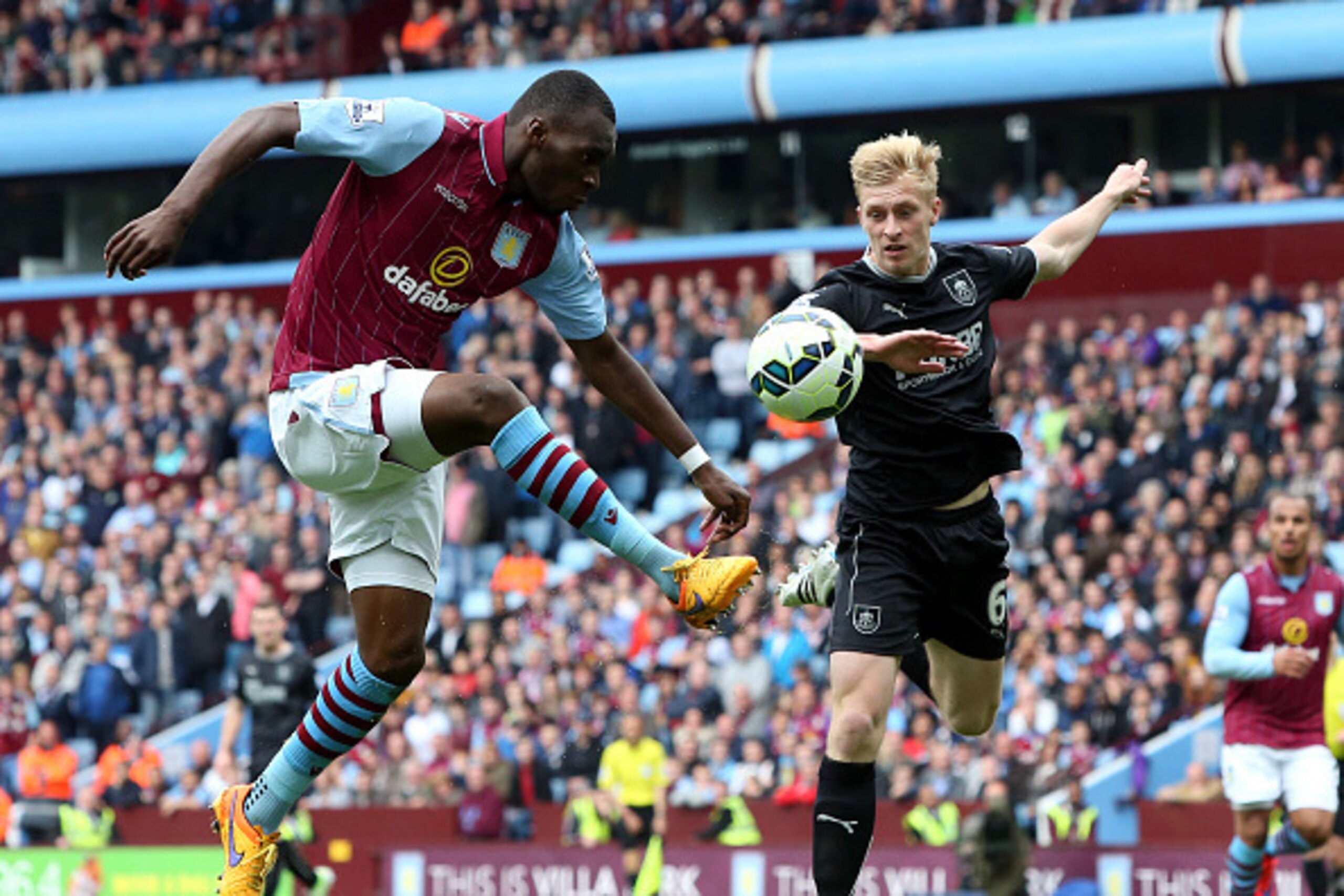 BIRMINGHAM, ENGLAND - MAY 24: Christian Benteke of Aston Villa shoots at goal as Ben Mee of Burnley intercepts during the Barclay's Premier League match between Aston Villa and Burnley at Villa Park on May 24, 2015 in Birmingham, England.  (Photo by David